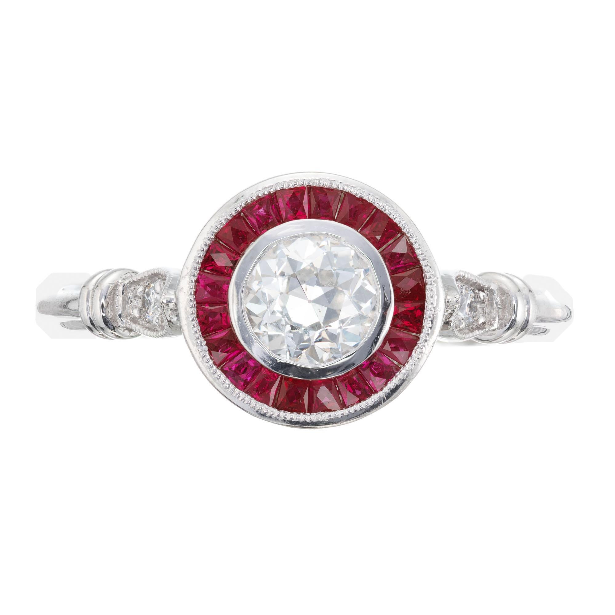 Diamond and sapphire engagement ring. EGL certified Old European round center diamond with a halo of calibre custom cut rubies in a platinum setting, with two diamonds on each side of the shank. Created in the Peter Suchy Workshop. 

1 old European