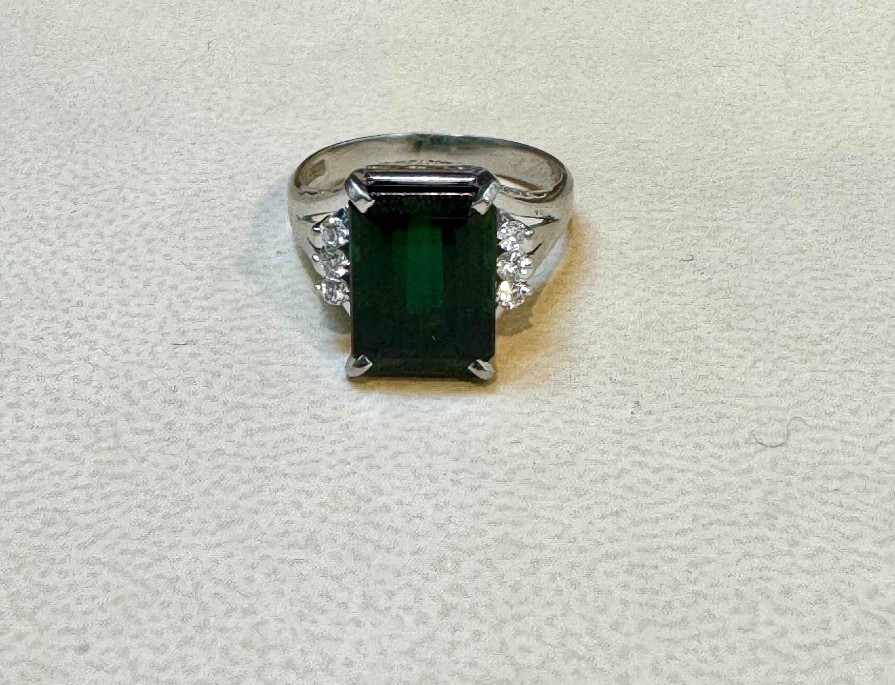 5.2  Carat  Emerald cut Green Tourmaline & 0.15 Carat Diamond Cocktail Ring 14 Karat White Gold Estate
This spectacular Cocktail ring   consisting of a single Emerald cut  Green Tourmaline .  The  Green Tourmaline  has three  brilliant cut  round