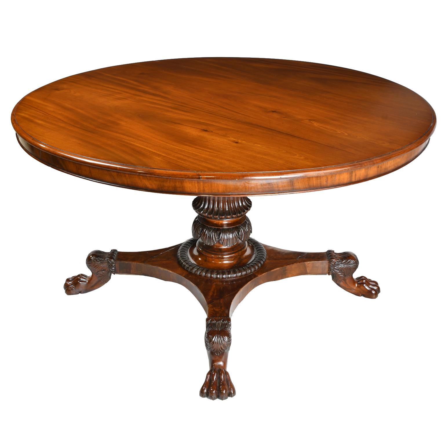 A beautifully articulated Danish Empire center pedestal table in fine mahogany with exceptionally well-carved turned pillar on quatre-form base terminating on four lion's paw feet. This remarkable piece would make an elegant hall table or an