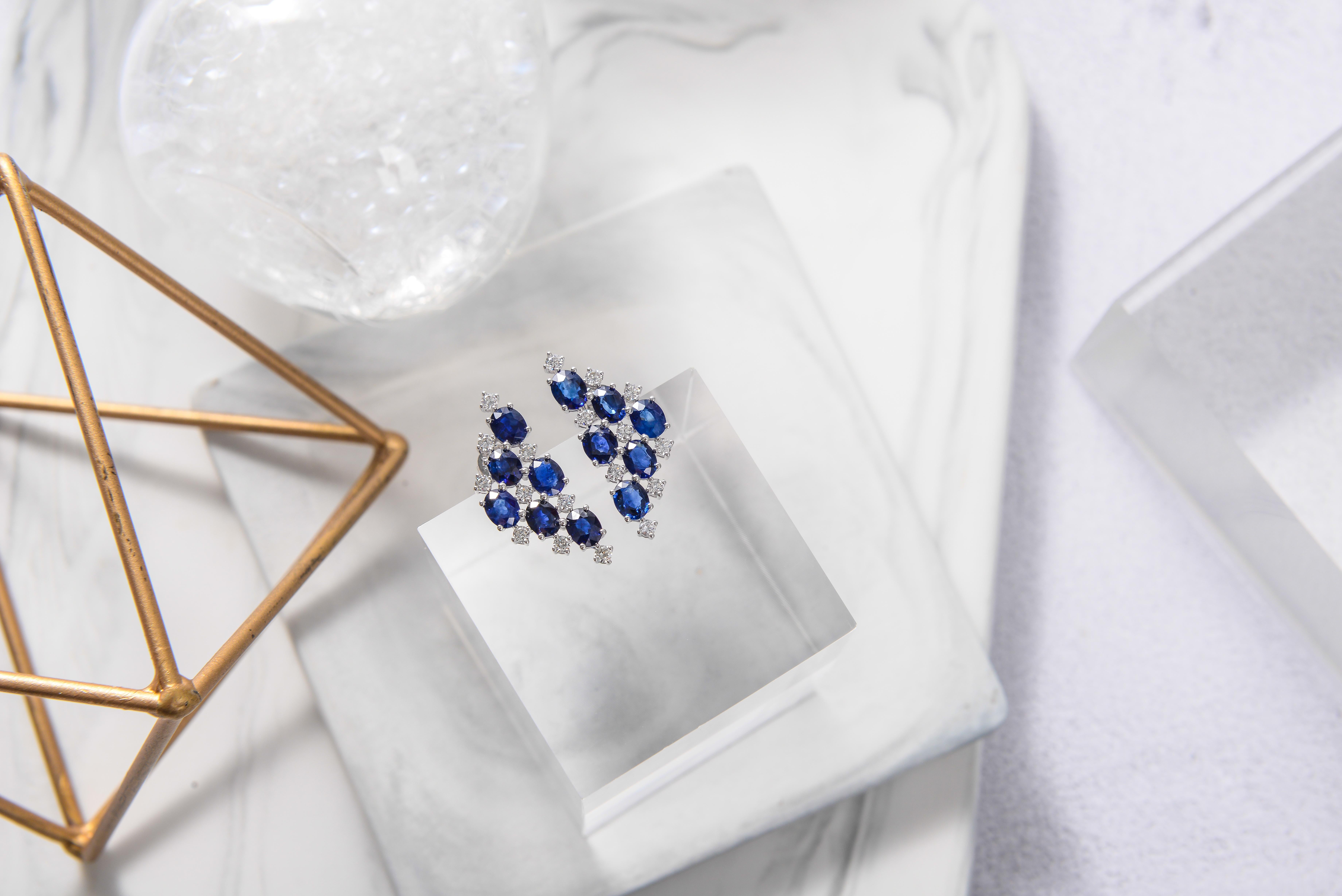 The Earring is in a triangle geometric design with Sapphire and Diamond alternating each other on a opened frame work. The opened frame setting allows more lights to pass through and therefore brighten the colour of the sapphire. The orientation of