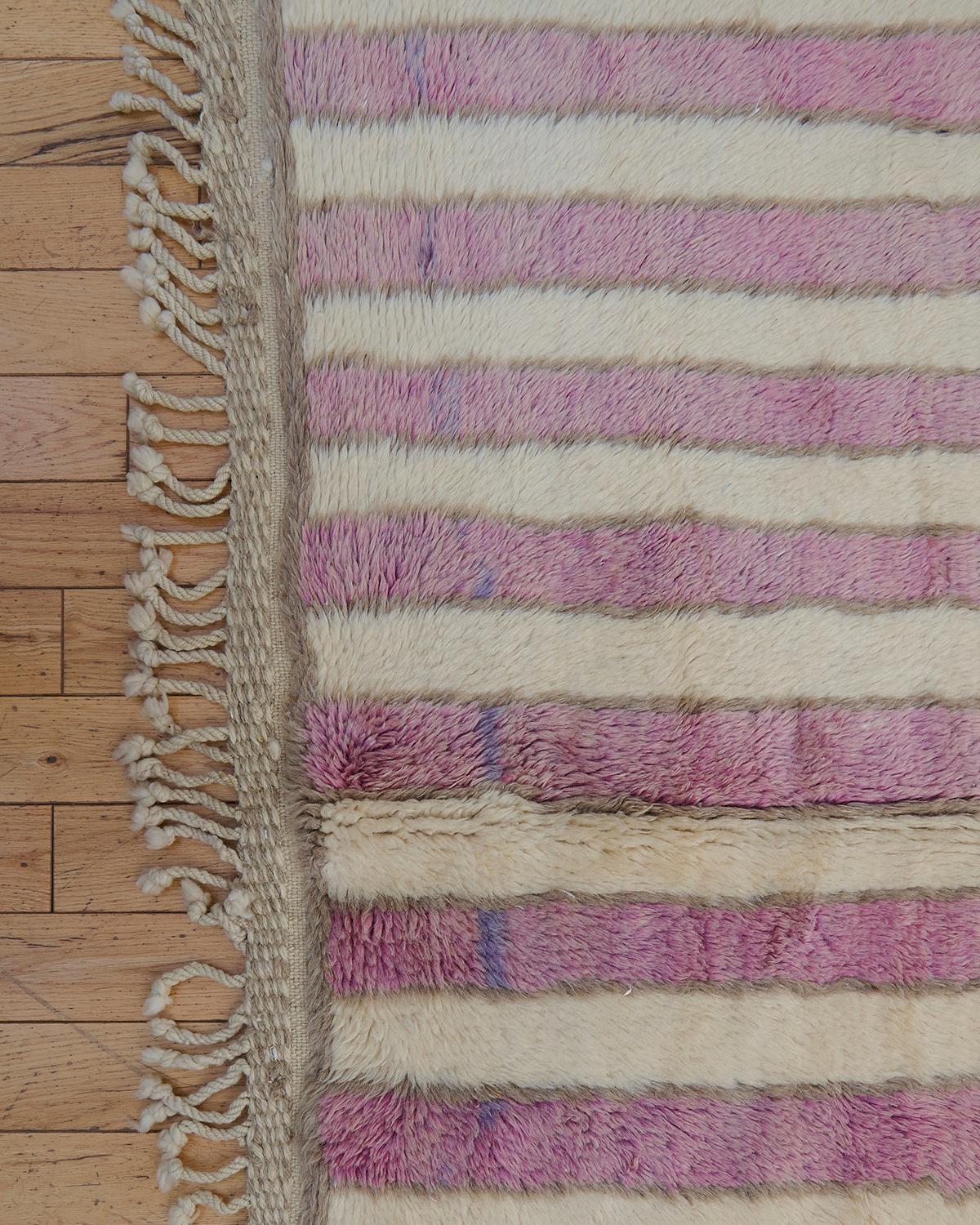 The Cynara rug is a luxurious Beni M’rirt piece, handwoven in Morocco using 100% natural sheep’s wool. Featuring a beautiful blend of cream and soft pink tones, this rug boasts intricate designs crafted with double knots, a hallmark of the Beni