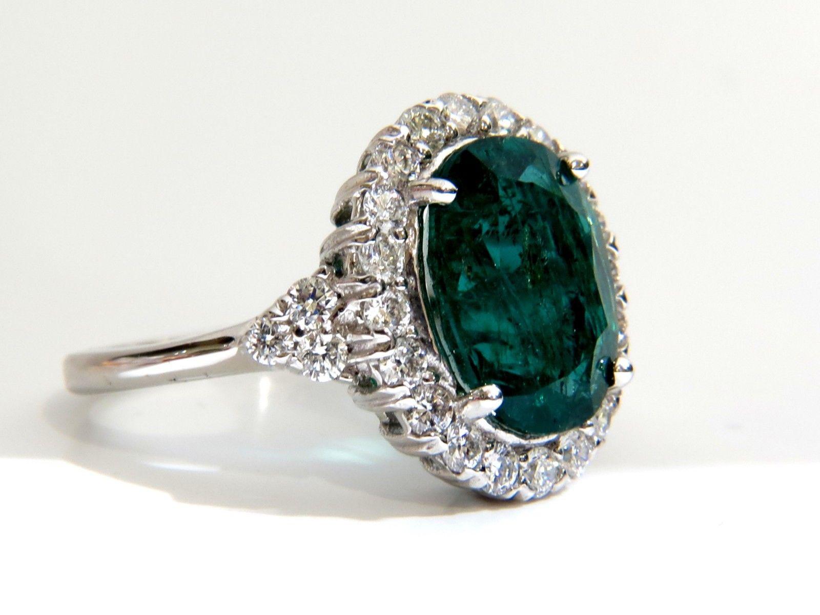 4.10ct. Natural emerald & 1.10ct. diamonds ring.

Round cut emerald, Excellent Clean Clarity

Brilliant Vivid Bright Green sparkles from all angles

Pristine Transparency

12.4 x 9.3mm 



1.10cts of Side round cut diamonds: 

Vs-2 clarity