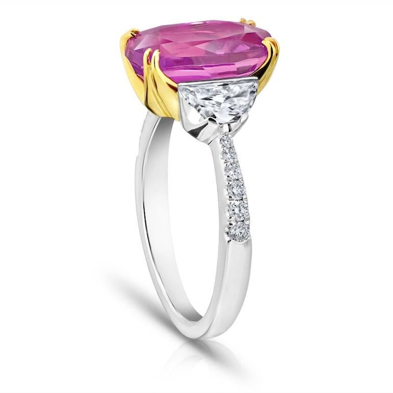 5.20 carat oval pink sapphire with two half moon diamonds weighing .61 carats and twelve brilliant cut diamonds weighing .14 carats all set in hand made platinum and 18k Yellow gold ring.
