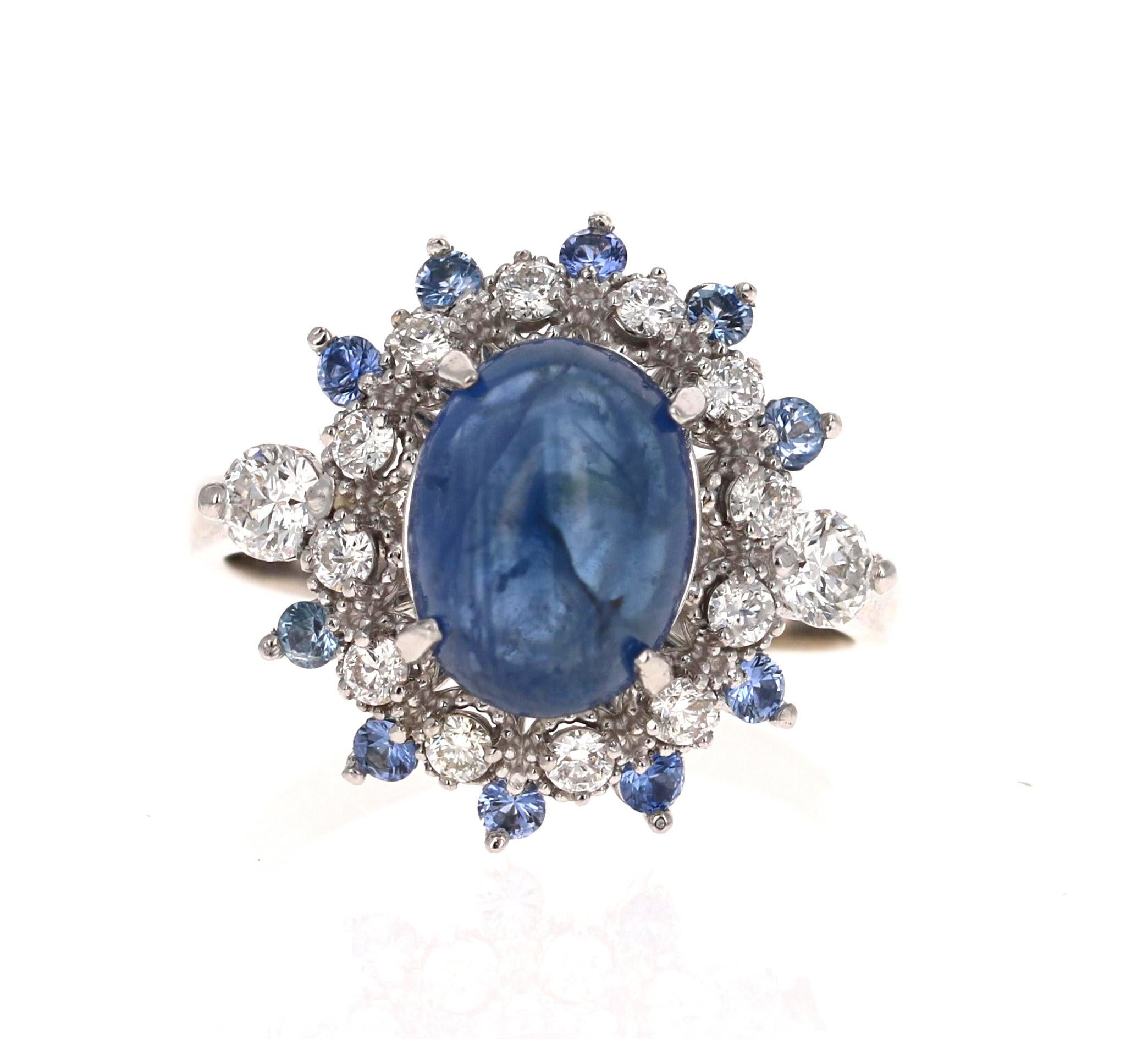  This ring has a Cabochon Blue Sapphire that weighs 4.10 carats set in the center of the ring. The Sapphire is surrounded by 14 Round Cut Diamonds that weigh 0.56 carats (Clarity: SI2, Color: F) and also has 12 Round Cut Blue Sapphires that weigh