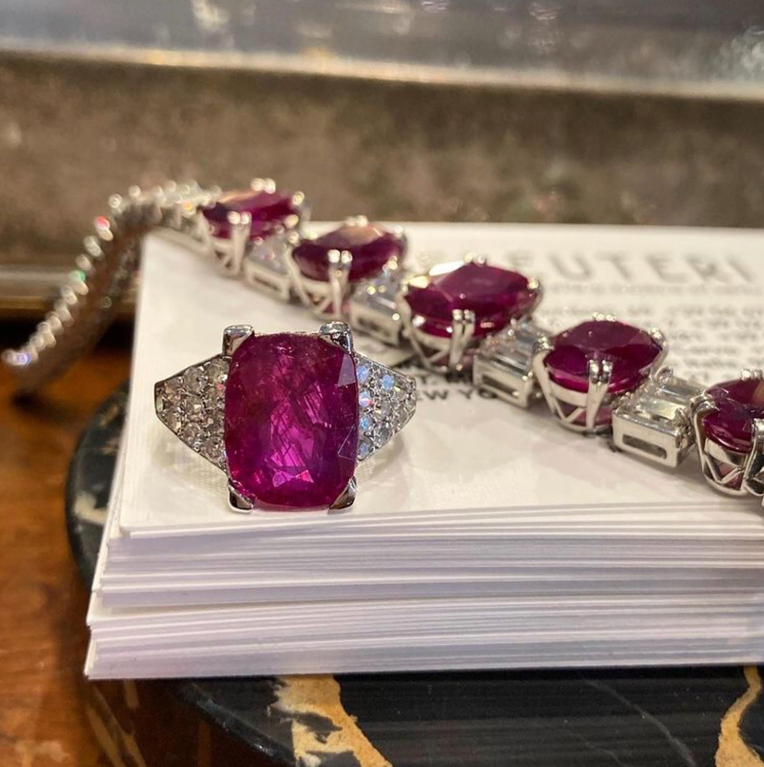 A stunning white gold filigree ring featuring a 5.20 carat no-heat Burmese rectangular cut ruby, accented by 20 round brilliant cut diamonds.  Accompanied by a certificate for the ruby. Circa 1950. 