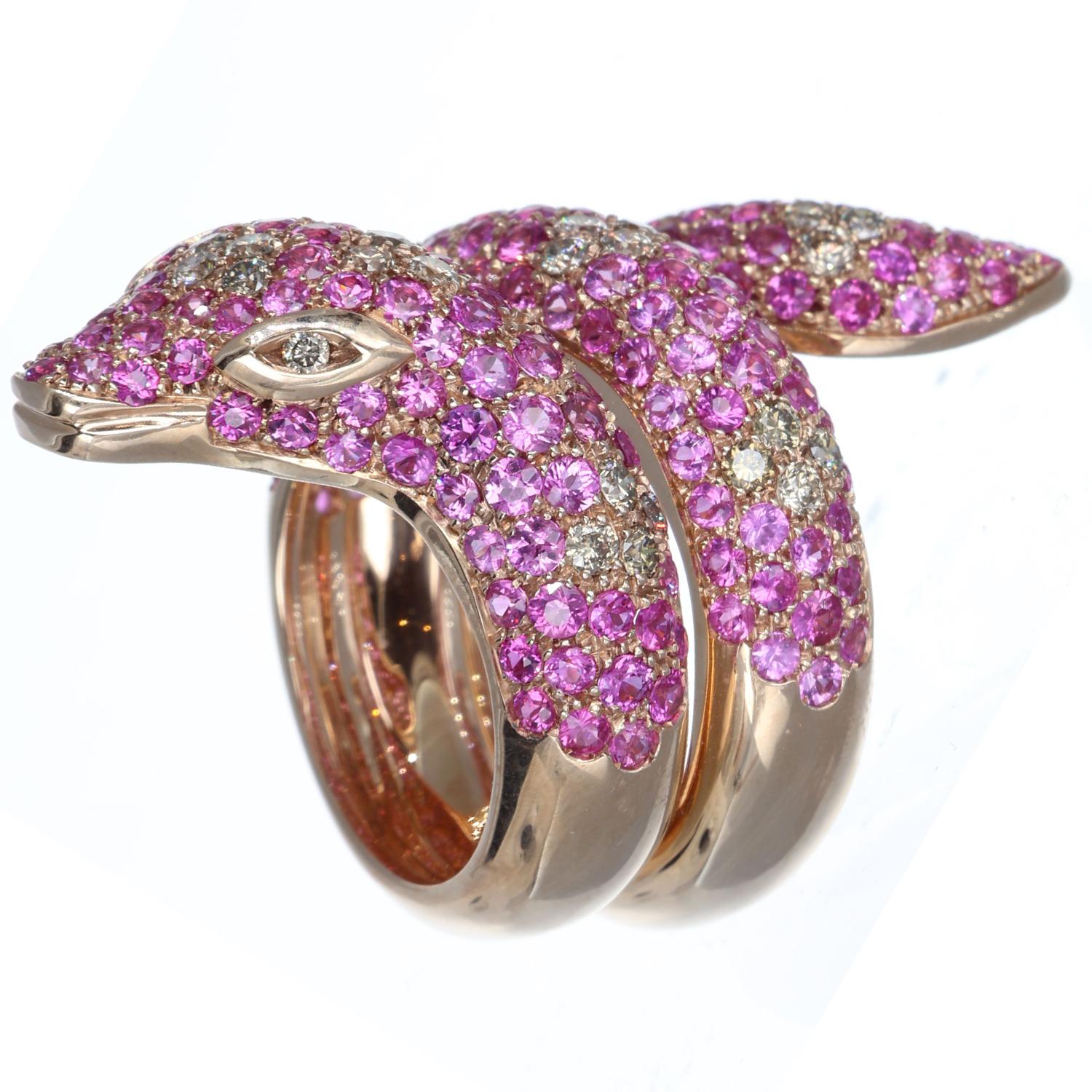 The 9kt rose gold snake ring is a captivating symphony of hues and radiance, a jewel that wraps the finger with a promise of enduring beauty. Pink sapphires, weighing 5.20 ct, deck this piece with burning passion, while 0.83 ct brown diamonds