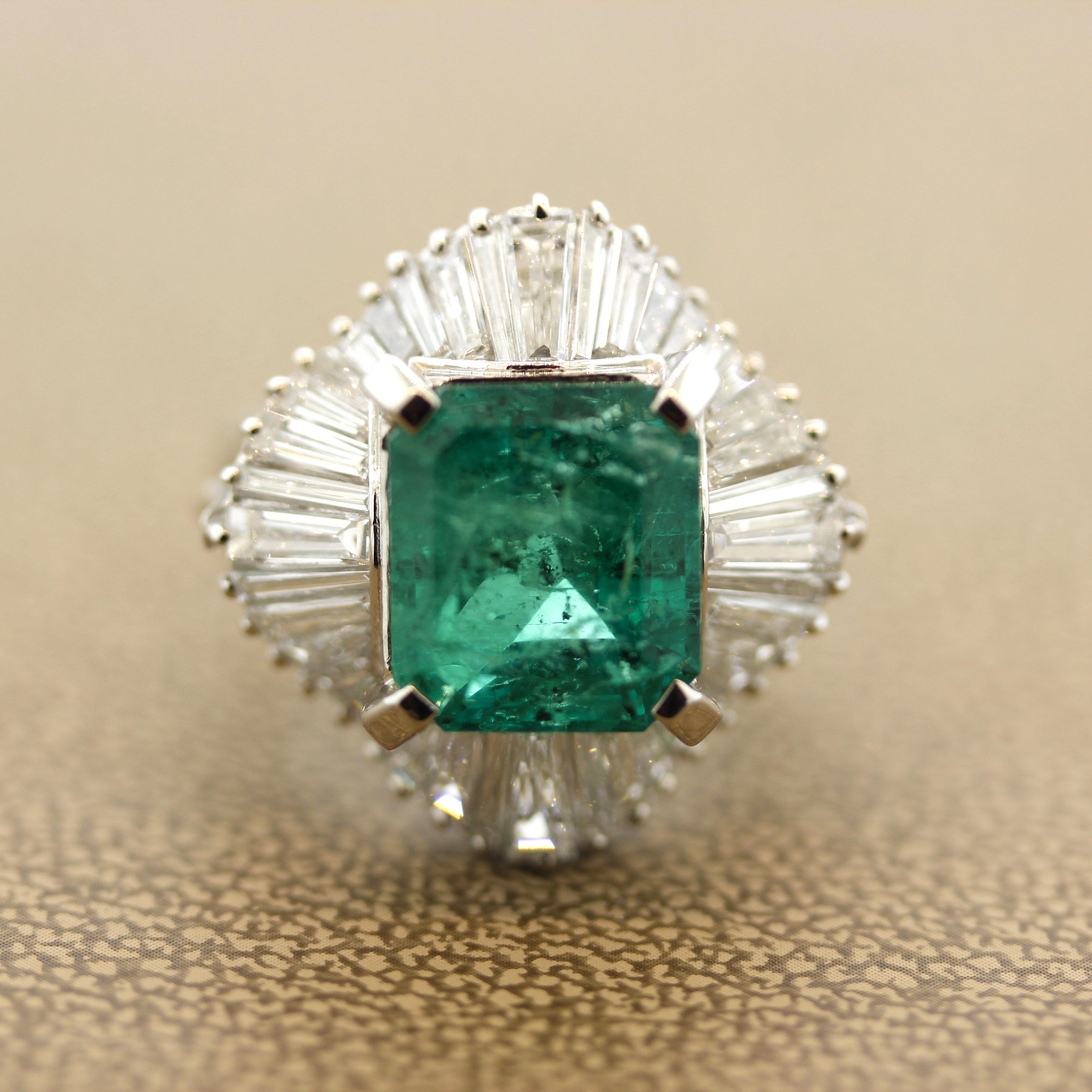 A large and substantial platinum ring featuring an impressive gem emerald weighing 5.21 carats. The emerald has a beautiful rich yet bright grass green color which is just so pleasing to look into. The clarity of the stone might not be the best, but