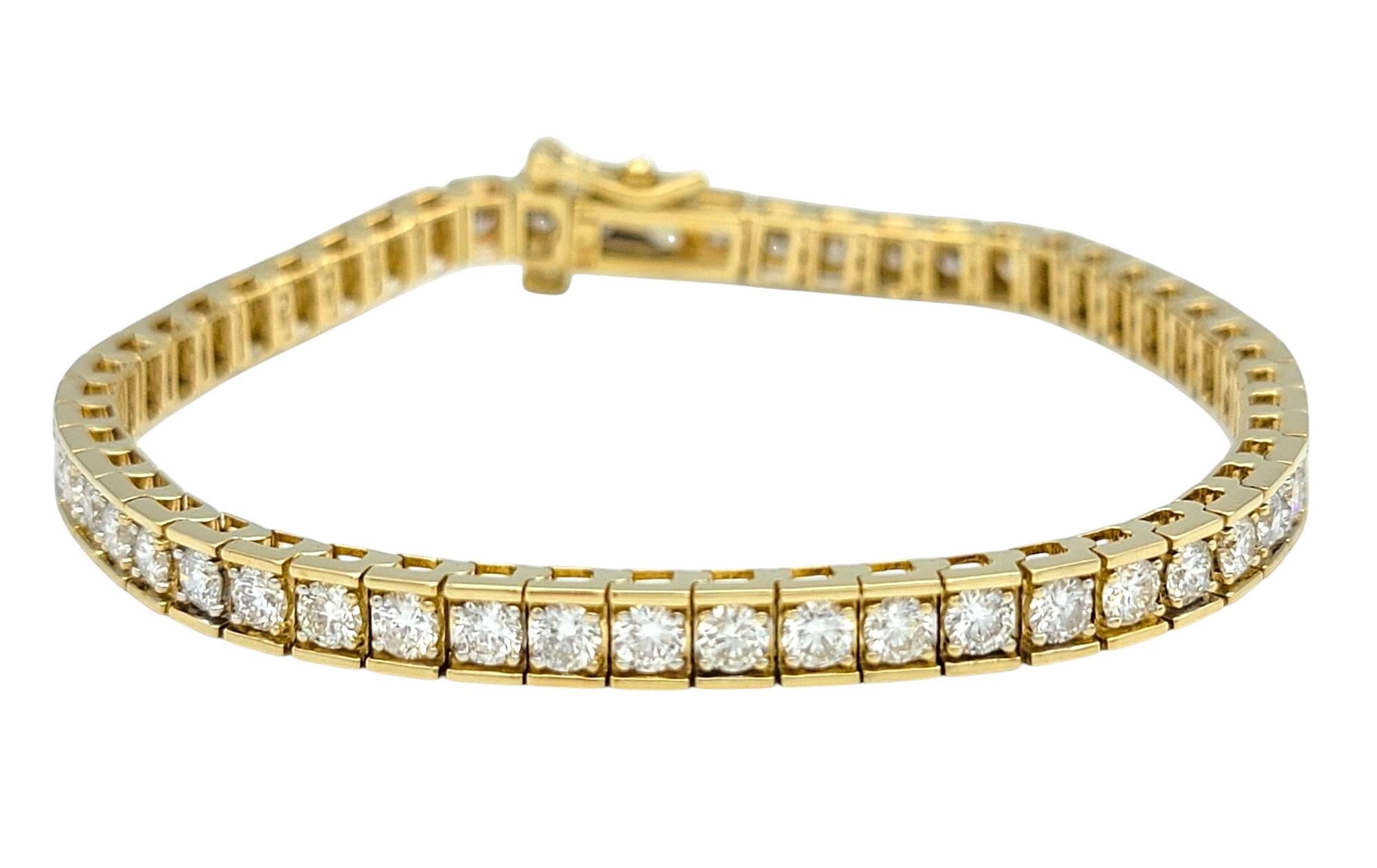 This stunning diamond tennis bracelet is crafted in luminous 14 karat yellow gold, designed with a classic link style that drapes gracefully around the wrist. A continuous row of round brilliant cut diamonds catches the light from every angle,