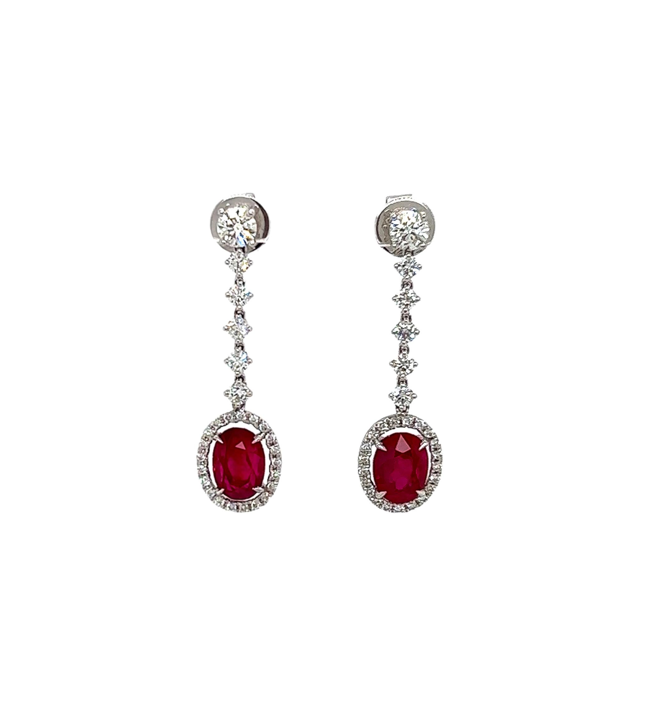 5.21 Total Carat Ruby and Diamond Drop Earrings in 18K White Gold

This gorgeous pair of Ruby earrings are sure to draw all eyes on you. It is created with generous 4.03 Carats worth of Oval cut rubies, surrounded by a halo and drop decorated with