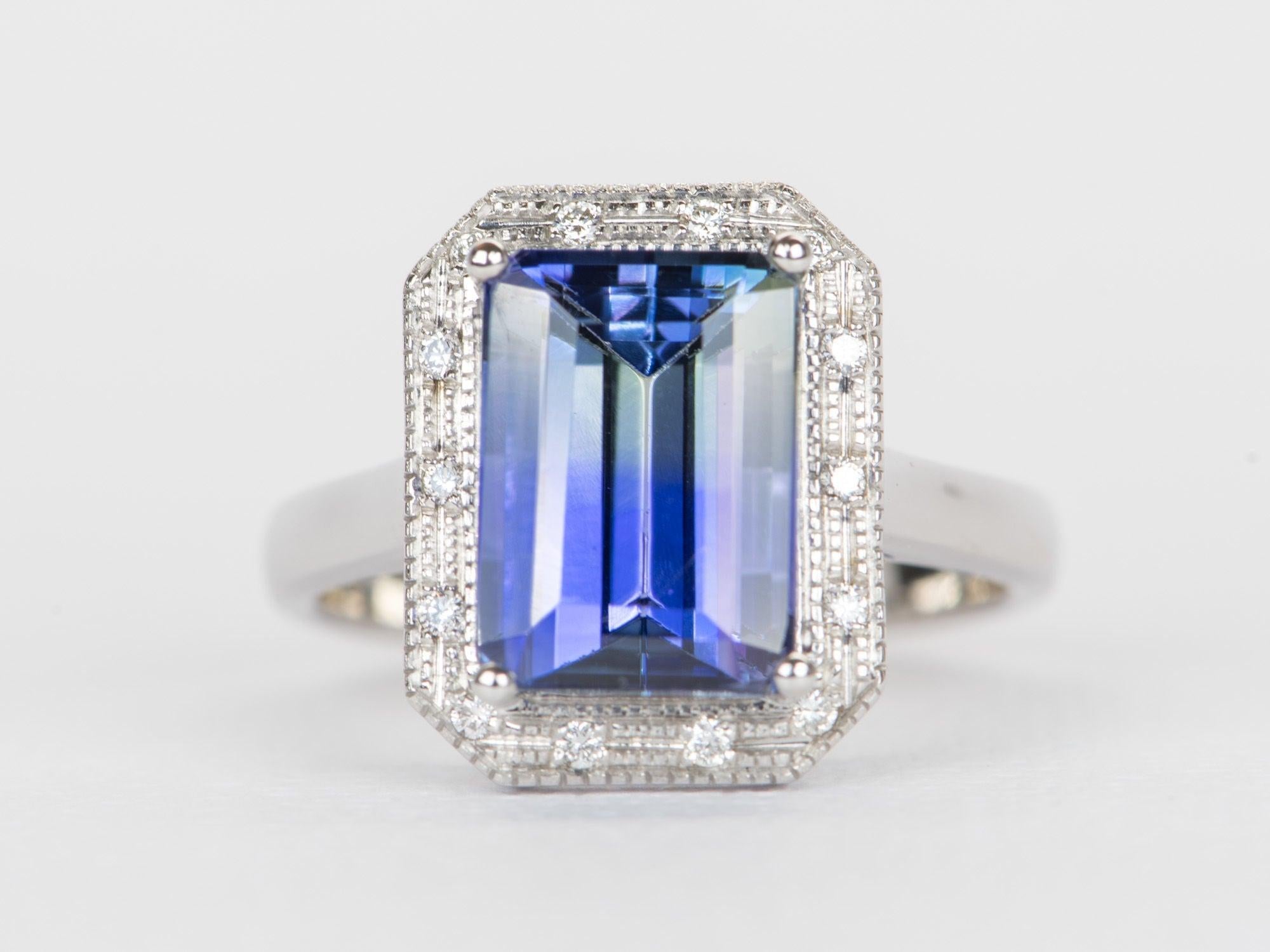 ♥ 5.21ct Bi-Color Purplish Blue Tanzanite with Diamond Halo 14K White Gold Ring
♥ Solid 14k white gold ring set with a beautiful emerald-shaped tanzanite
♥ Gorgeous bi-color color!
♥ The item measures 15.1 mm in length, 11.9 mm in width, and stands