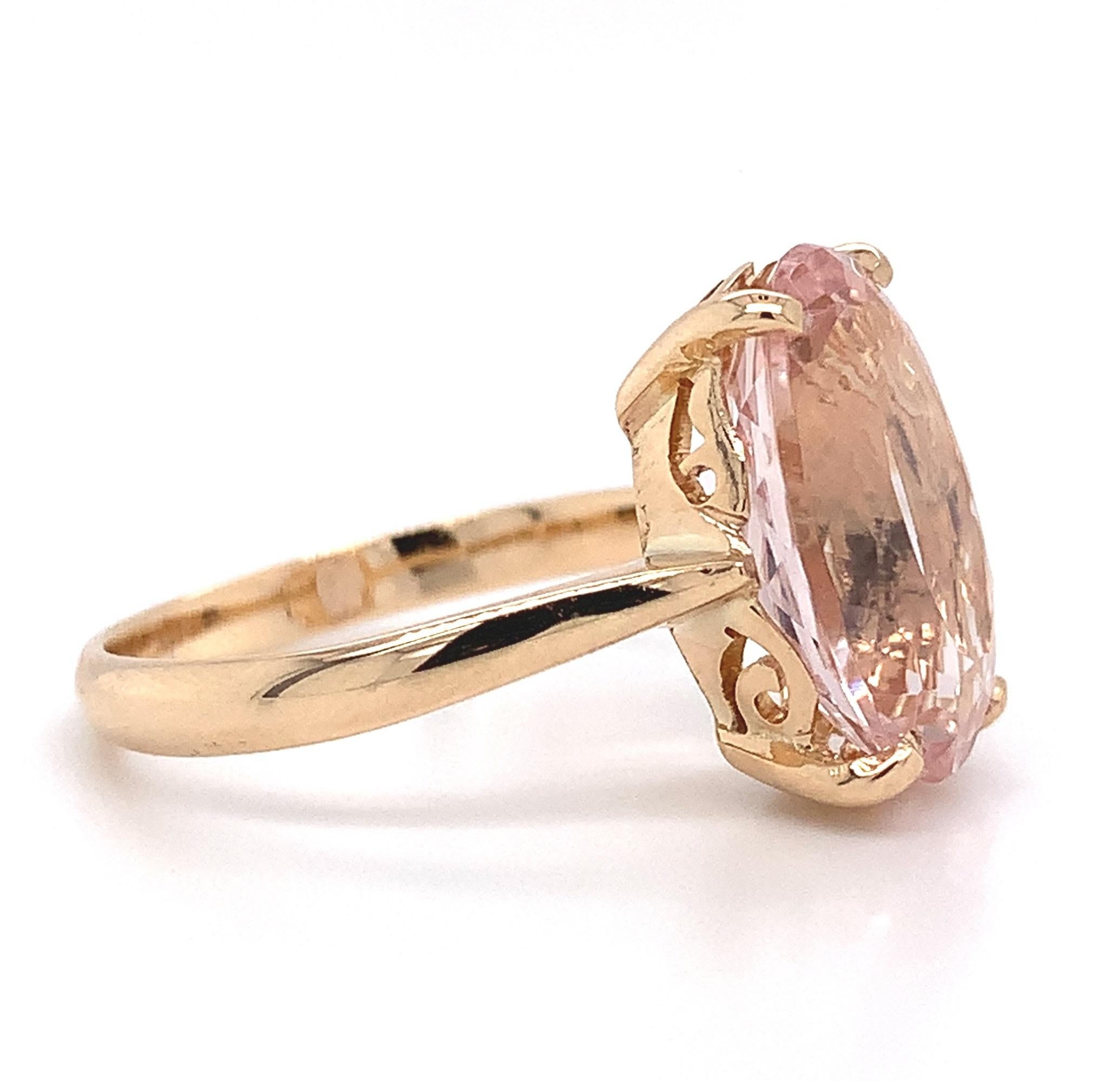 14K yellow gold vintage ring featuring an oval morganite weighing 5.21 carats. The morganite has light pink/peach color and measures about 14mm x 10mm. Morganite is the peach or pink variety of beryl (aquamarine). The mounting is hand pierced with