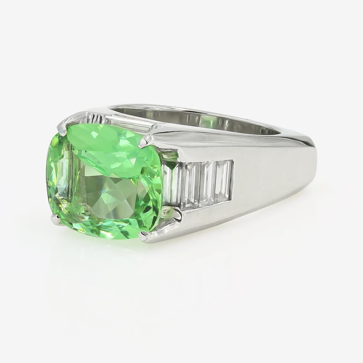 This exquisite ring has a natural green beryl cushion cut center=5.22cts. It also contains 12 straight baguette diamonds weighing approximately 1.30cts. t.w. (The baguettes are G in color and VS in clarity) The entire ring is made in
