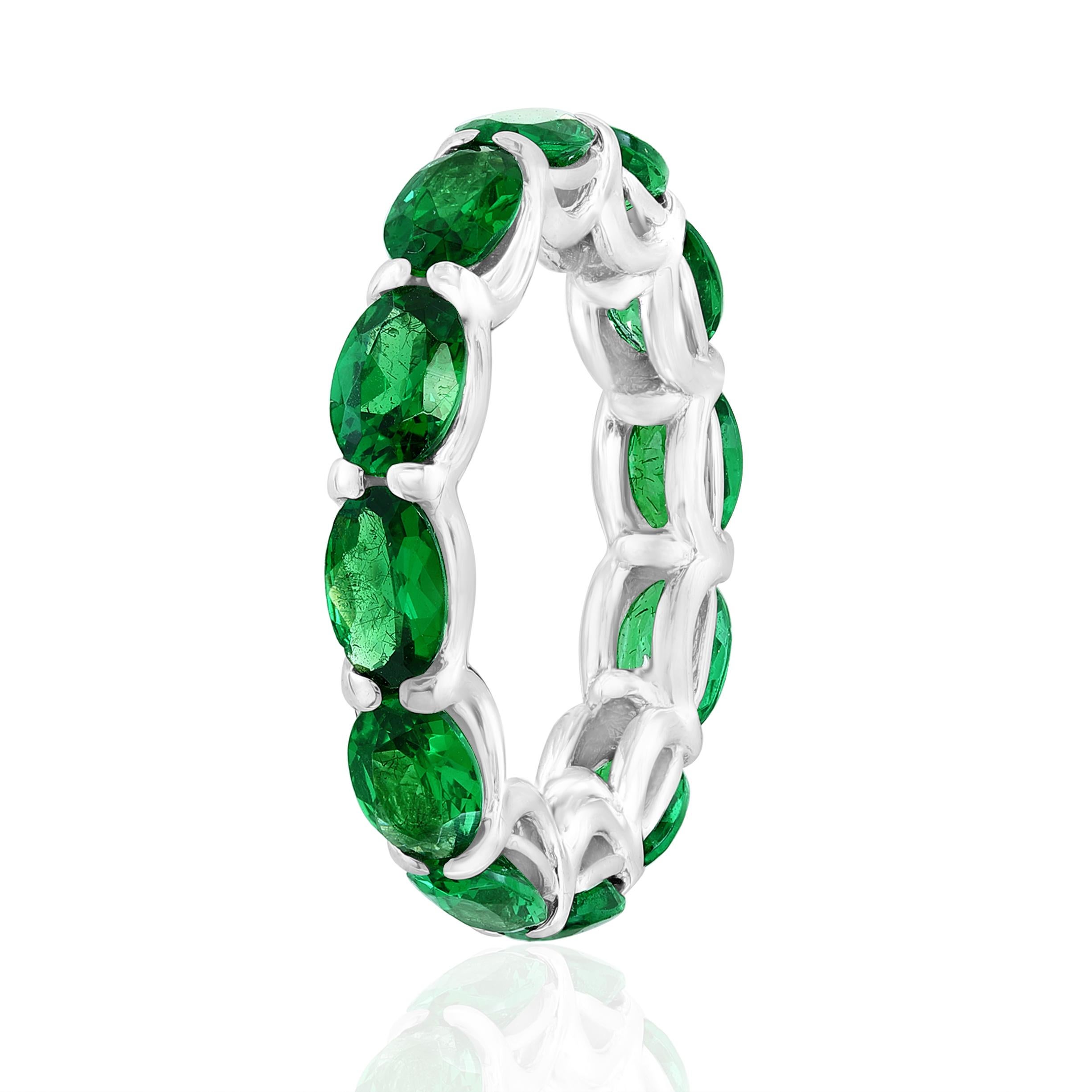 12 perfectly matched Green Tsavorites in a 18 Karat White Gold Eternity Ring setting.

5.22 Carats.

Custom ordered to be made like picture and specifications. 