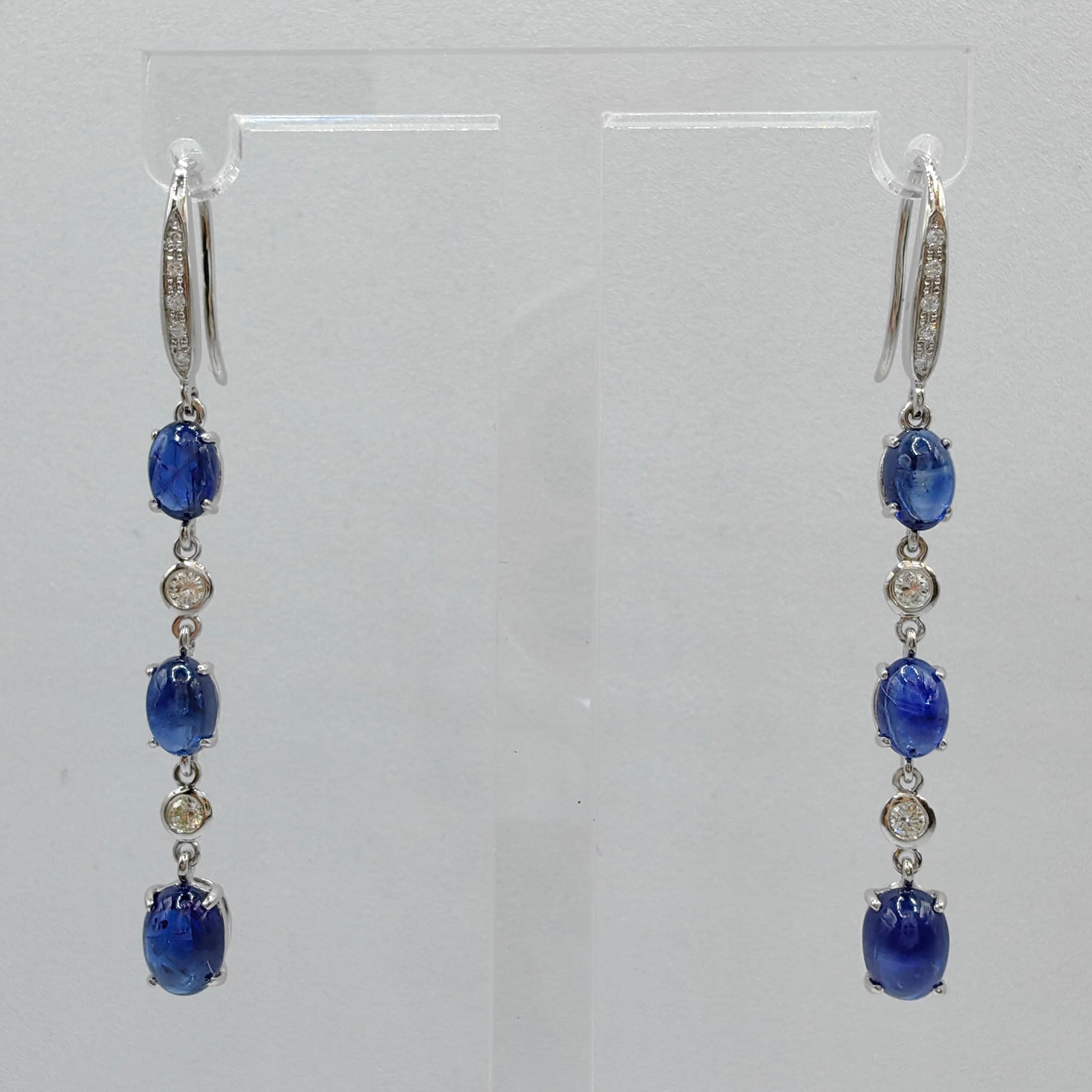 Experience the epitome of luxury and elegance with our exquisite 5.22ct Cabochon Royal Blue Sapphire Diamond Dangling Earrings in 18K White Gold. These captivating earrings are designed to make a statement and leave a lasting impression.

At the
