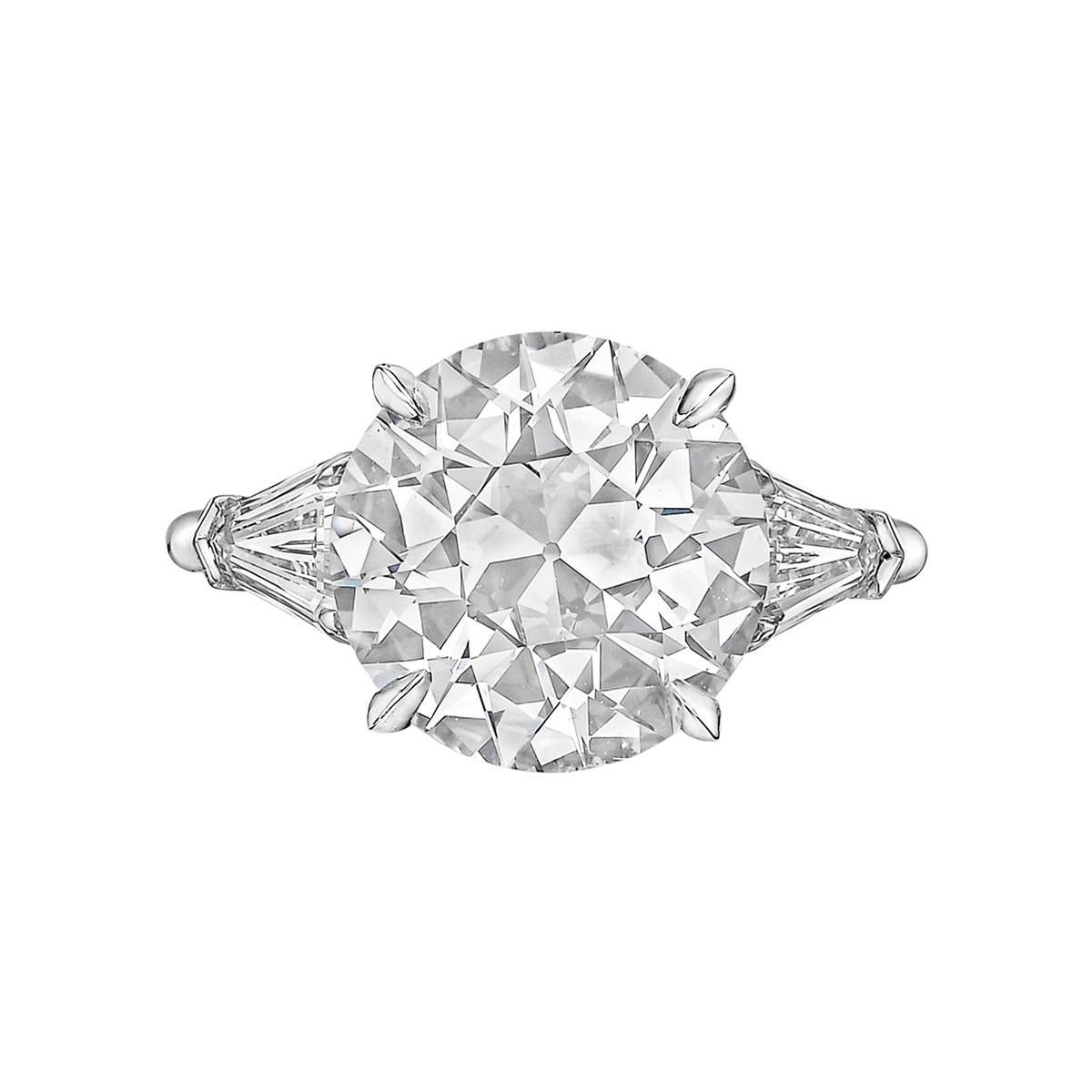 Diamond engagement ring, centering a colorless old European brilliant-cut diamond weighing 5.22 carats (F-color, SI1-clarity) with shield-cut diamond side stones, mounted in platinum.

Two shield-cut diamonds weighing 1.04 total carats (E-color,