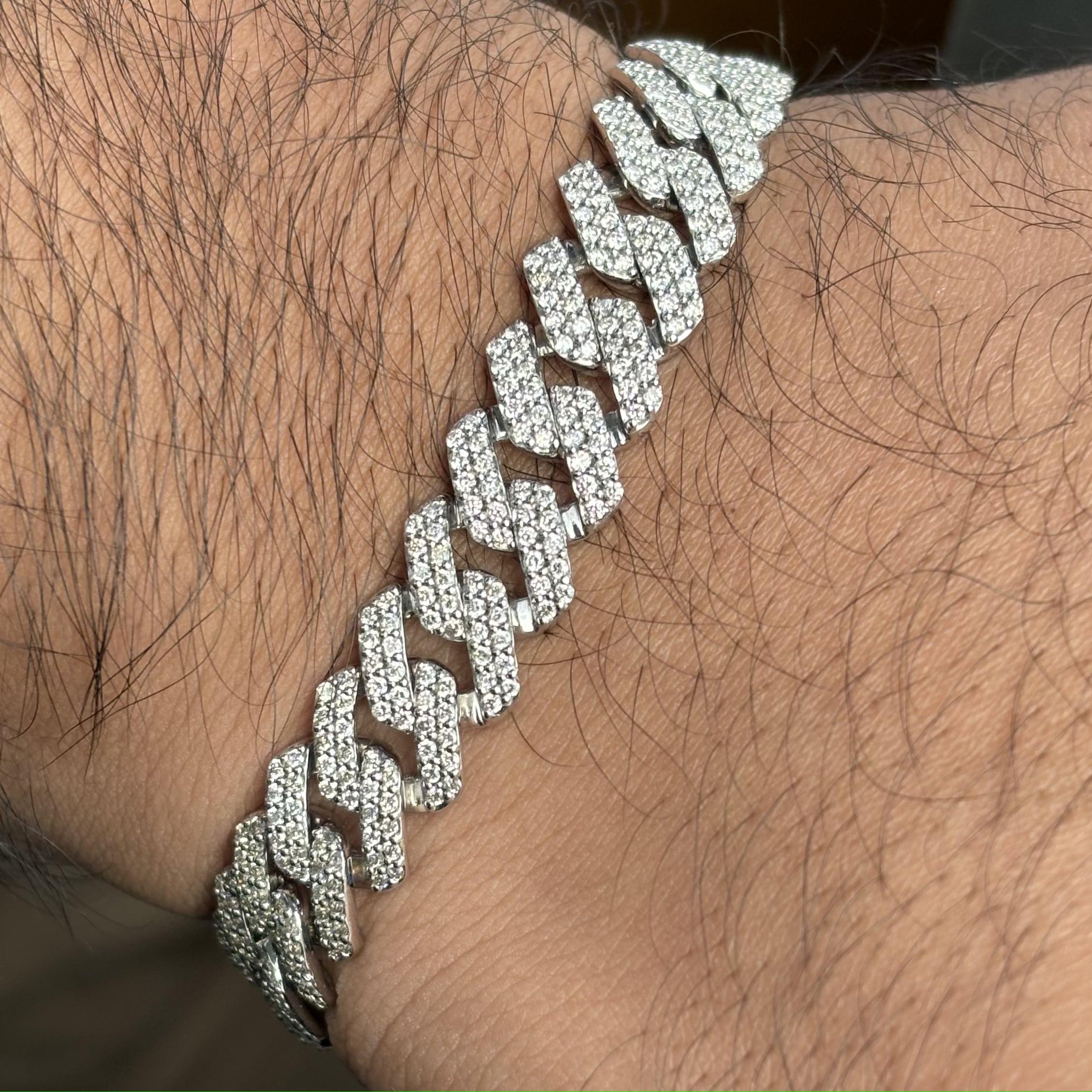 Introducing this classic cuban link bracelet that is an essential addition to any gentleman's jewelry collection. Adorned with 5.23 Carat, G Color VS Clarity Natural Diamonds, this exquisite bracelet is crafted in 33.52 grams of 10K White