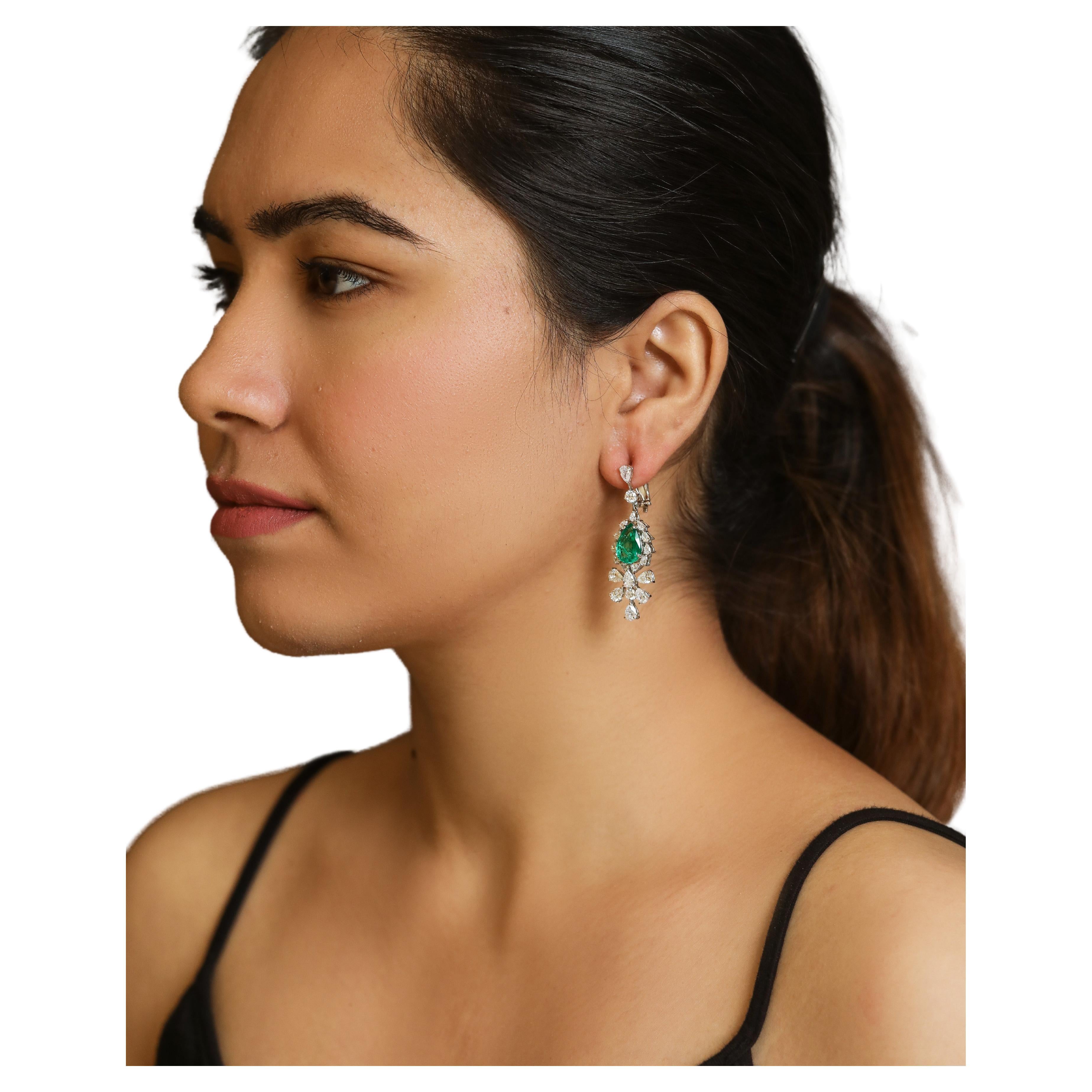 Handcrafted Earrings in 18K Gold Studded with Pear Shape and Round Diamonds with Natural Emerald.
Gold Weight - 10.465 gms

Diamond Clarity - VS
Diamond Colour - G/H

Emerald - Natural Emerald

Post and Clip System