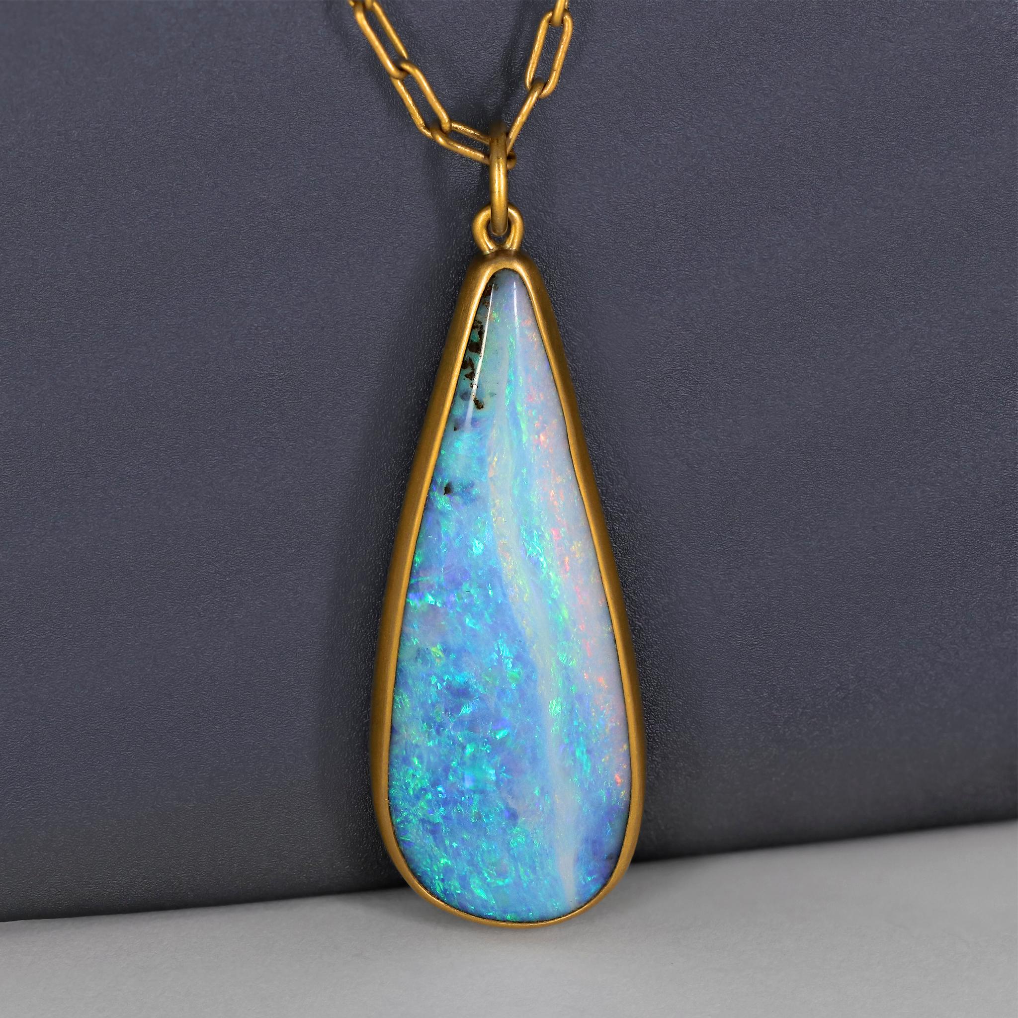 One of a Kind Necklace by jewelry maker Lola Brooks hand-fabricated in matte-finished 22k yellow gold featuring an extraordinary, rare 52.38 carat tear drop shaped blue boulder opal with phenomenal rainbow fire color play, bezel-set and finished on