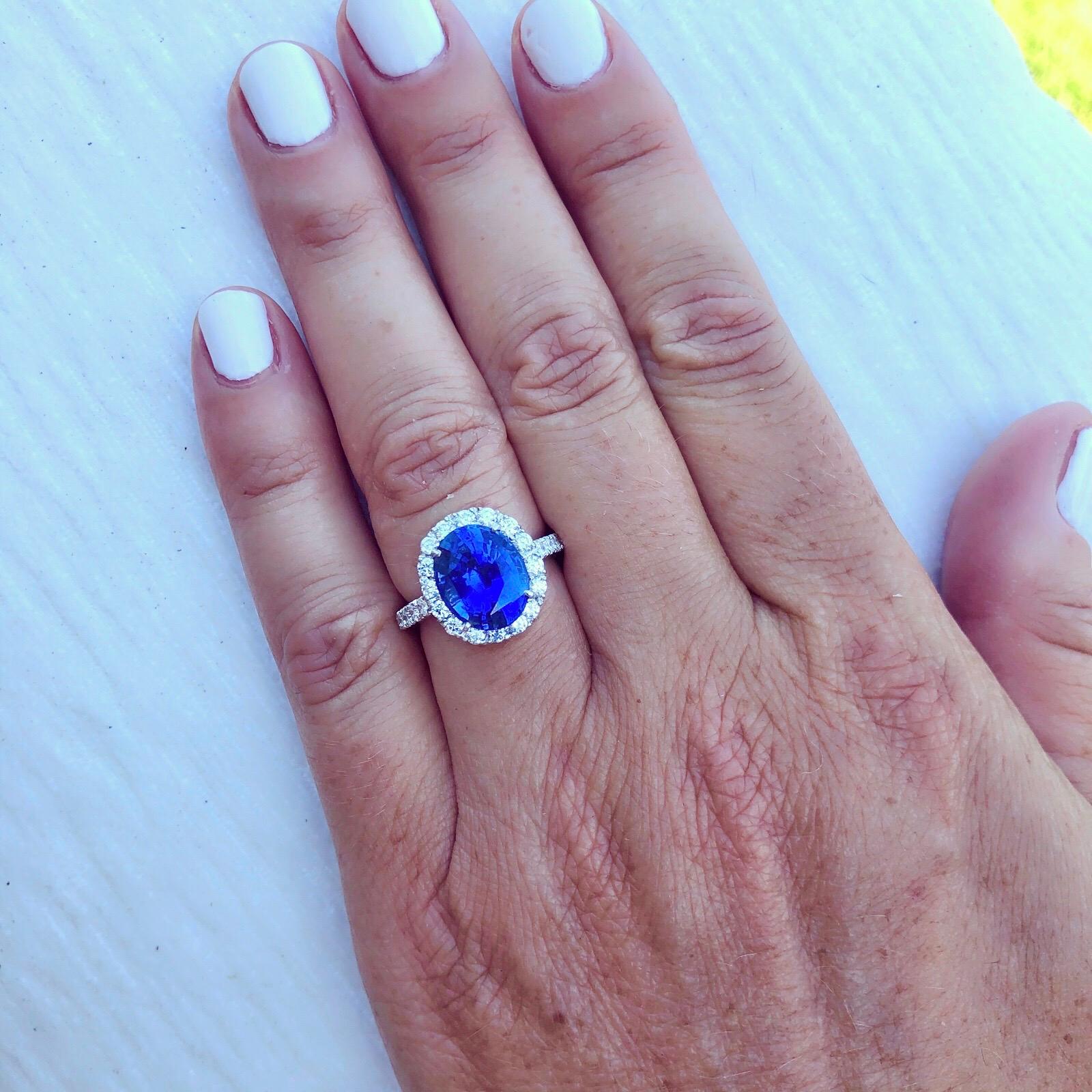 There is blue, and then there is BLUE! This exceptional platinum halo style ring features a Sri Lankan oval sapphire for 5.24 carats surrounded by 46 sparkling round diamonds for 1.06 carats (F-G color/VS clarity). Weighing 8.2 grams and accompanied