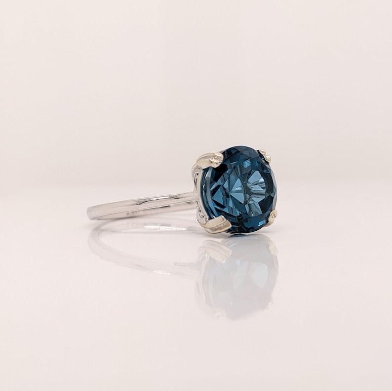This beautiful solitaire ring features a striking London Blue Topaz in 14k white Gold. A statement ring design perfect for an eye catching engagement or anniversary. This ring also makes a beautiful birthstone ring for your loved ones.

The