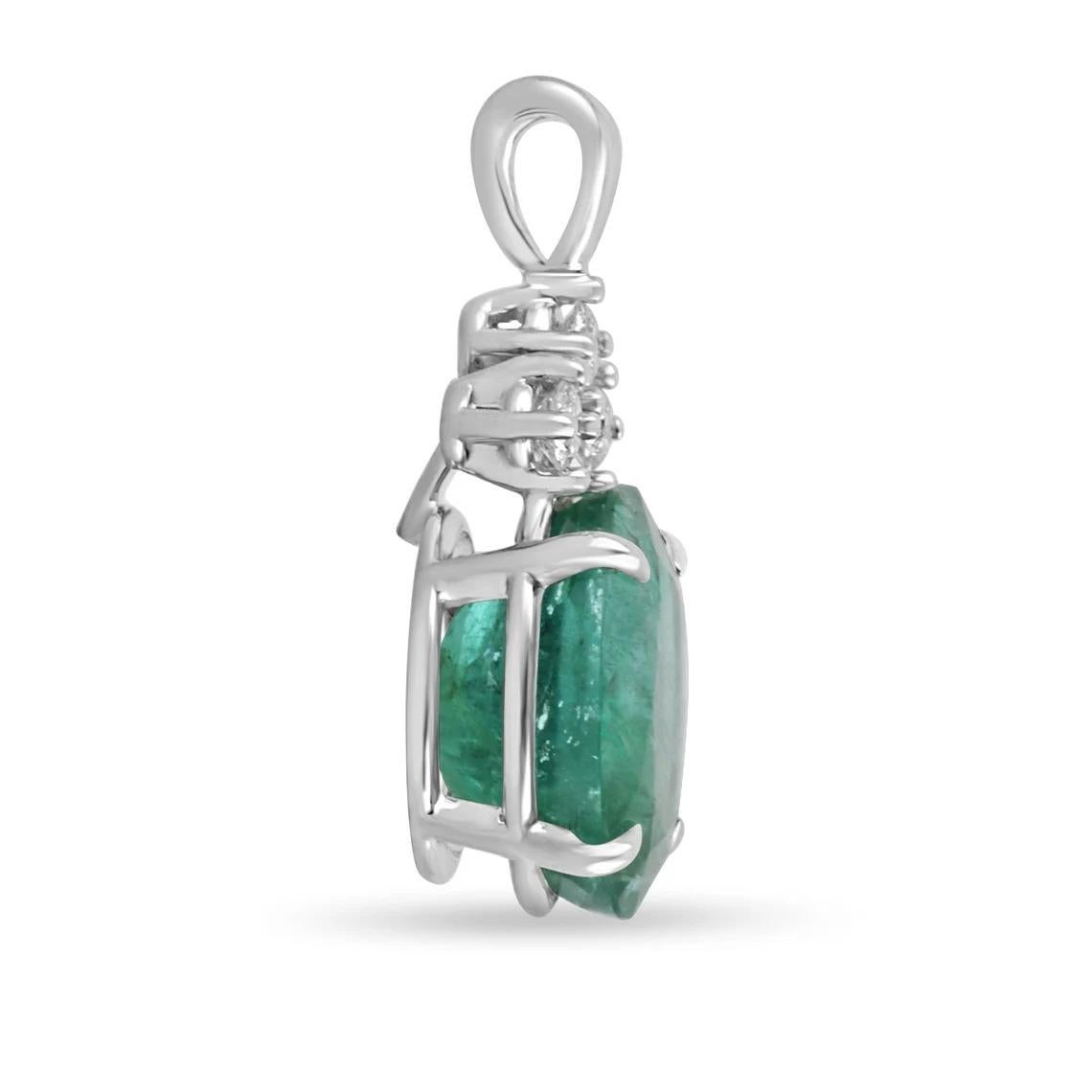 Featured here is a stunning oval emerald & diamond accent necklace in fine 14k white gold. Displayed in the center is a deep green emerald accented by a simple four-prong gold mount, allowing for the emerald to be shown in full view. Diamonds accent