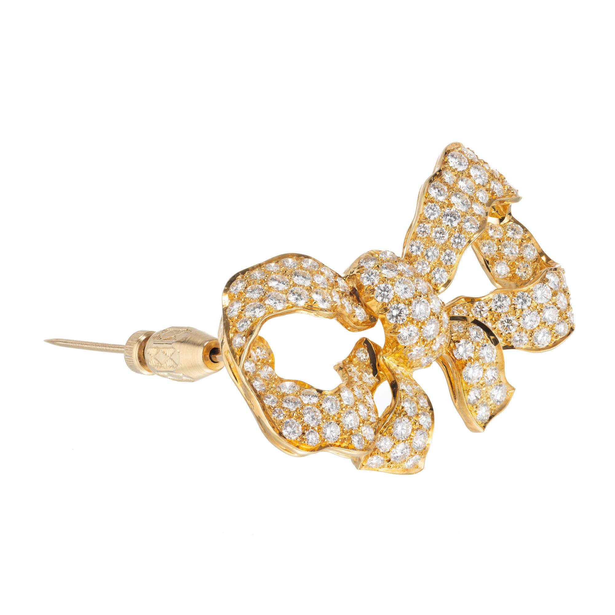 Custom made 18k yellow gold bow brooch set with 146 pave round brilliant cut diamonds. 

146 round brilliant cut diamonds, F-G VS approx. 5.25cts
18k yellow gold 
Stamped: 18k
16.7 grams
Top to bottom: 28mm or 1 1/8 Inch
Width: 47.1mm or 1 7/8
Depth