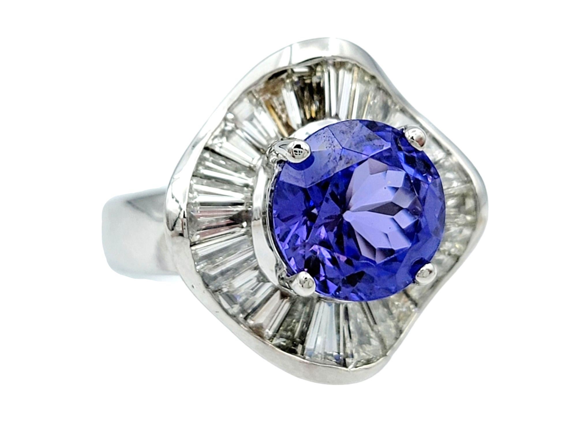 Ring Size: 7.5

Behold the beauty of our tanzanite and diamond ring, a captivating piece that seamlessly marries classic elegance with modern design. Set in a polished 18k white gold setting, this ring boasts a prong-set tanzanite that sits