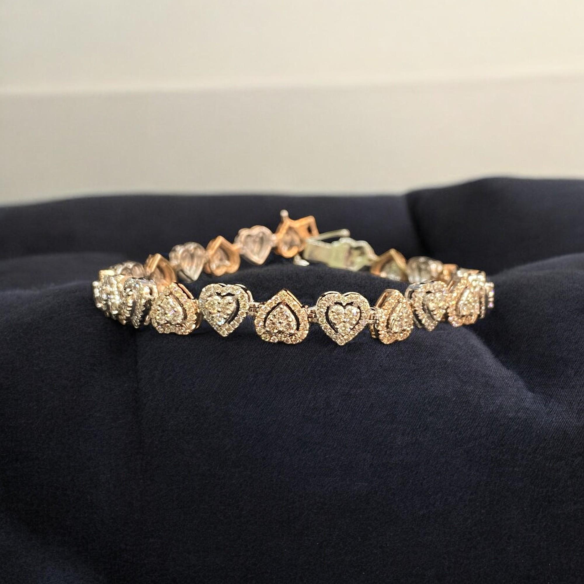 This exquisite bracelet features 5.25 carats of round brilliant-cut diamonds in a heart-shaped tennis design in 14K gold. Its stunning brilliance will surely bring out your most radiant smile and make you feel like royalty!

Specifications:
Metal :