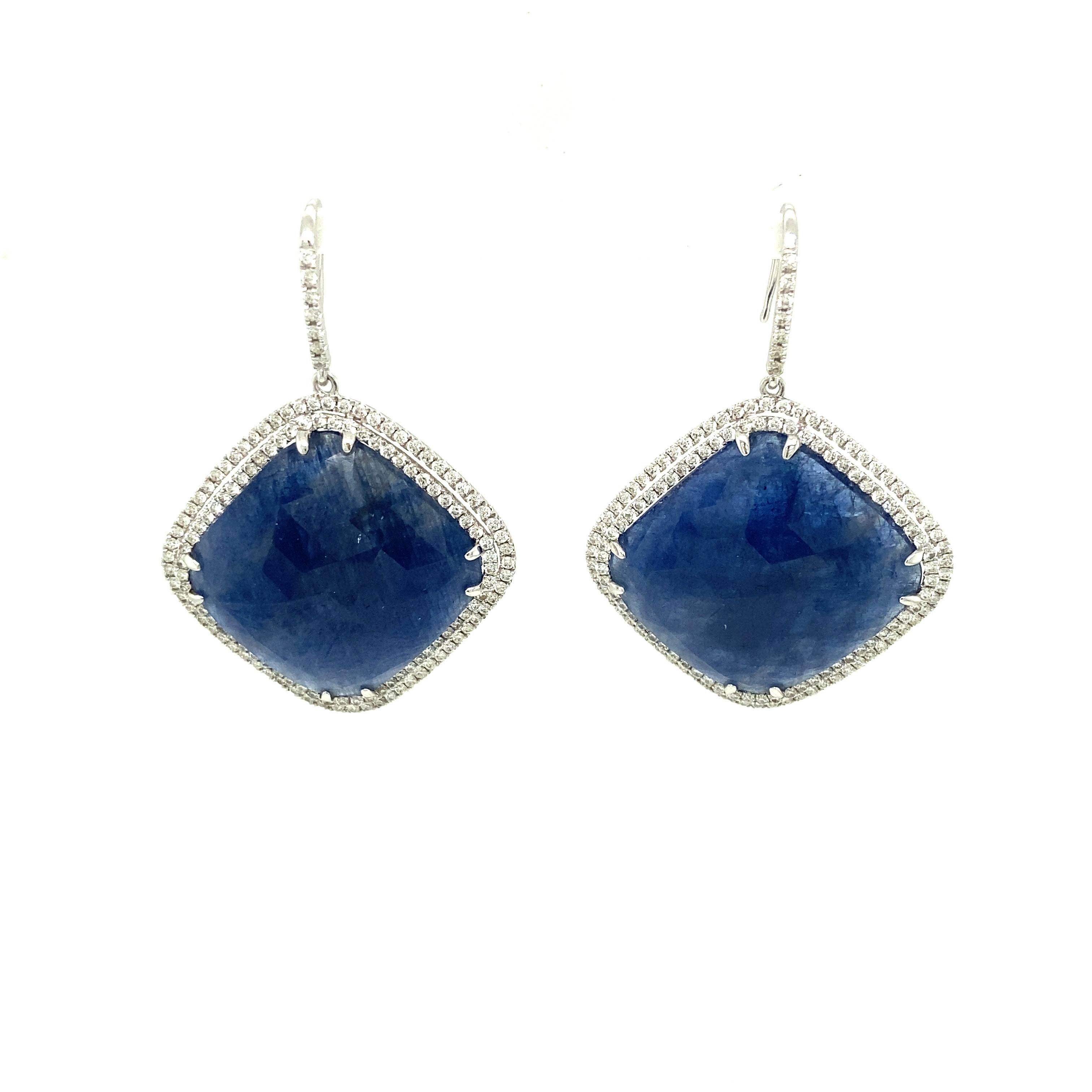 52.55 Carat GRS Certified Unheated Burmese Blue Sapphire and Diamond Earrings:

An elegant pair of earrings, it features two rose cut unheated Burmese cushion shaped blue sapphires weighing 52.55 carat along with a halo of white round brilliant