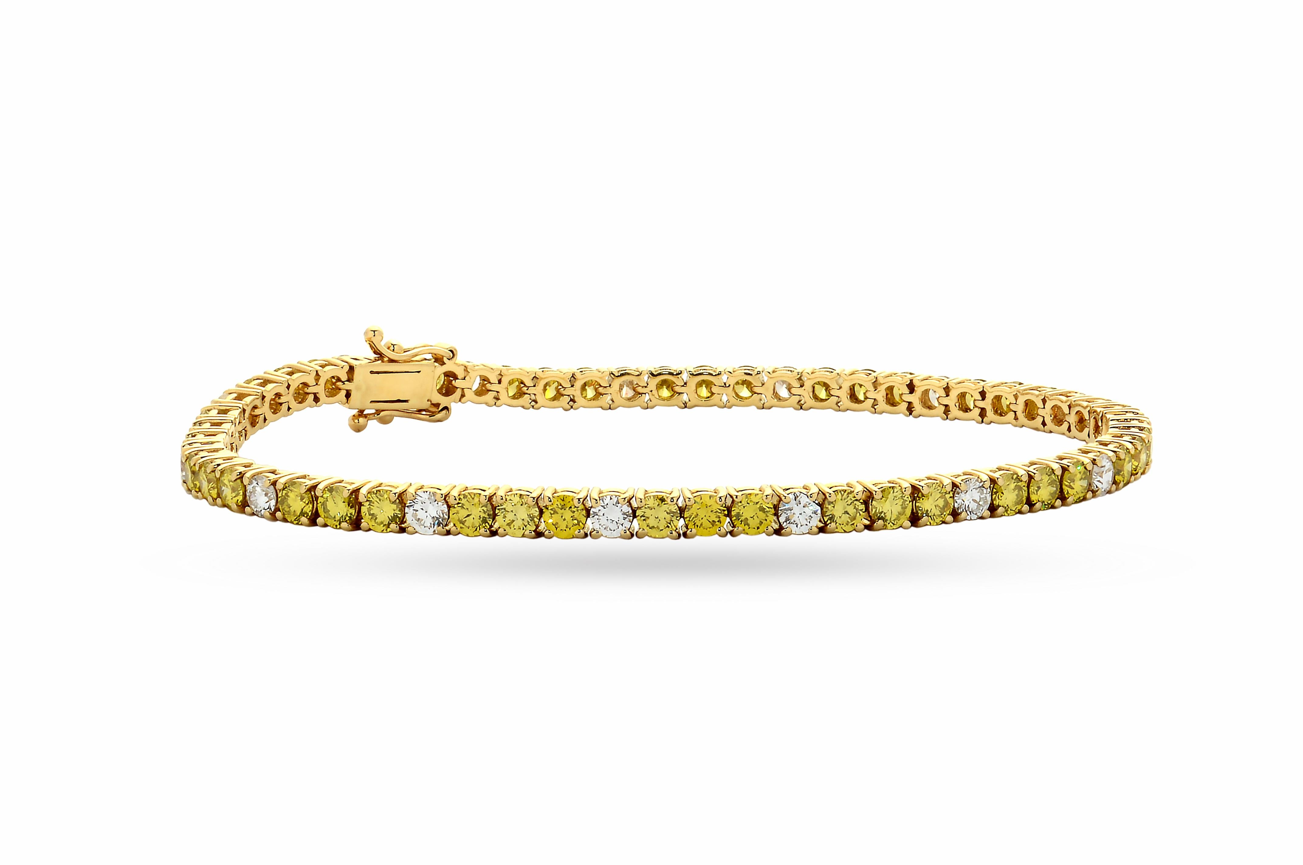 Stunning 18-karat yellow gold tennis bracelet with a total carat of 5.25ct mixed set with brilliant cut fancy yellow diamonds and brilliant cut natural white diamonds: color F/G, clarity V-S quality. 

This is a no turn riviera bracelet and has a