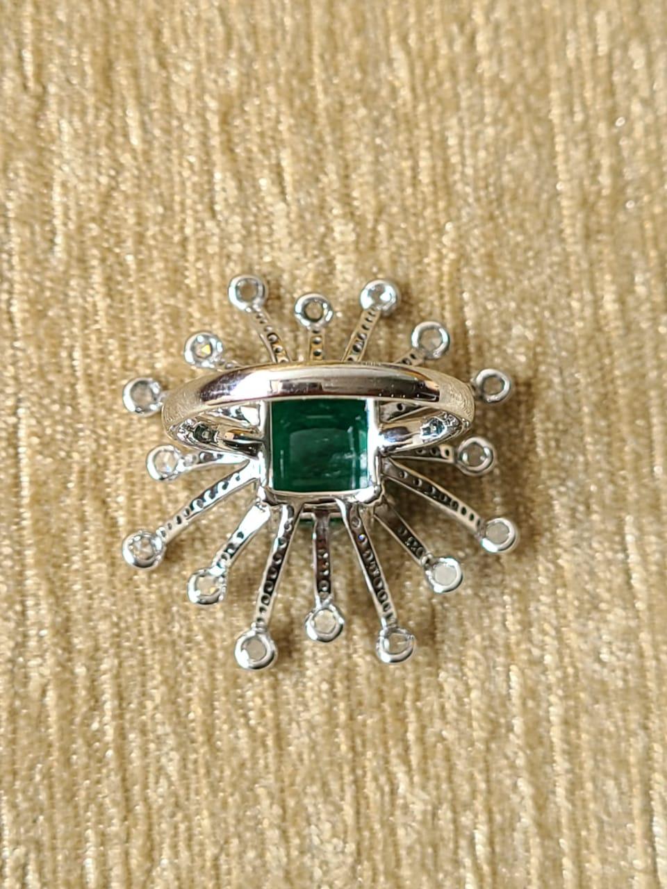 A pretty cocktail ring set in 18k white gold with natural emerald and natural diamonds. The natural emerald weight is 5.26 carats and diamond weight is 1.23 carats. The net gold weight is 6.892 grams and ring dimensions in cm 3.1 x 3.1 x 3 (LXWXH).