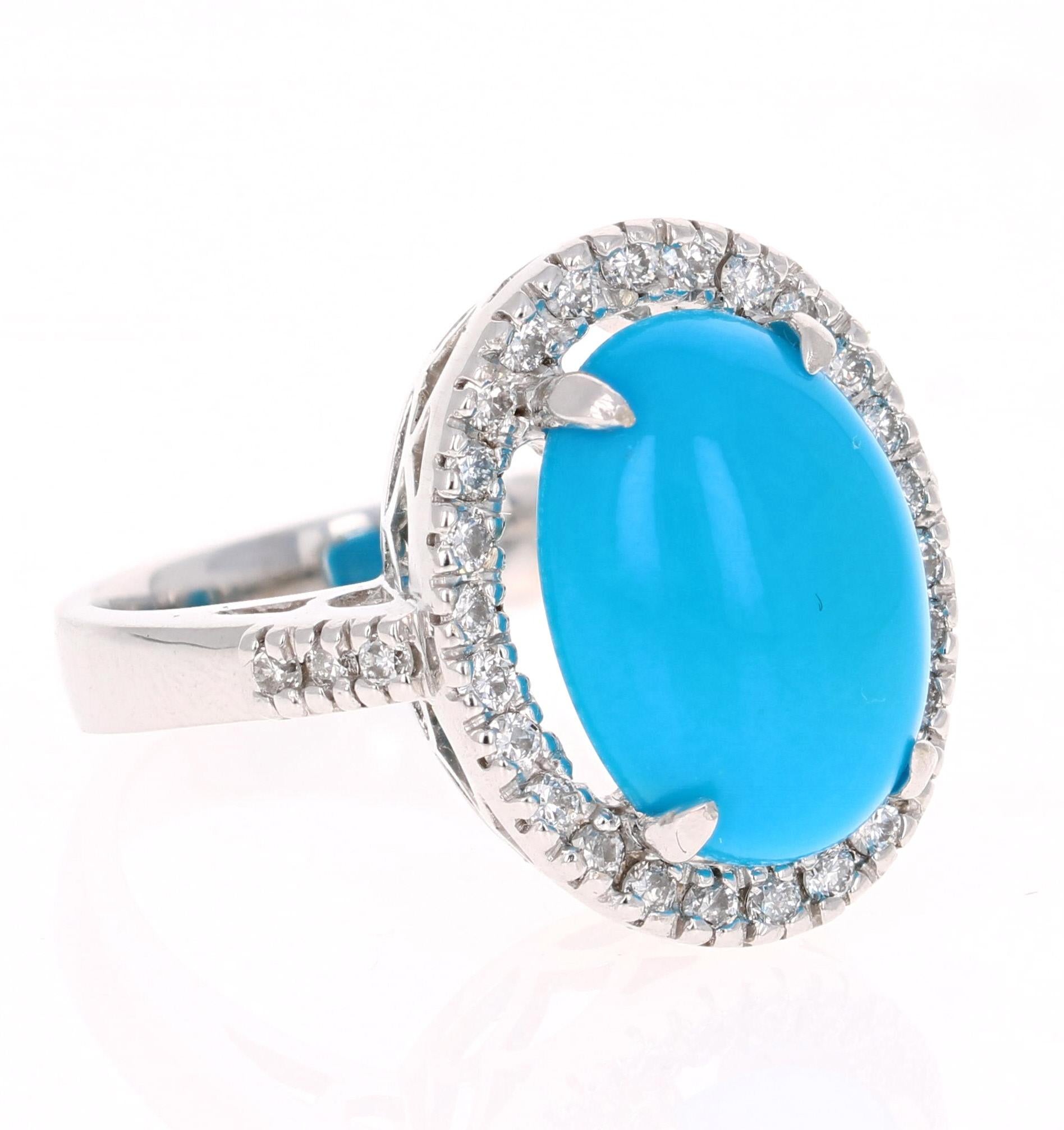 Beautiful Turquoise Diamond Cabochon Cocktail Ring!
The Oval Cut Cabochon Turquoise is 4.79 Carats and has a halo of 32 Round Cut Diamonds weighing 0.47 Carats. The total carat weight of the ring is 5.26 Carats. 

It is crafted in 14K White Gold and