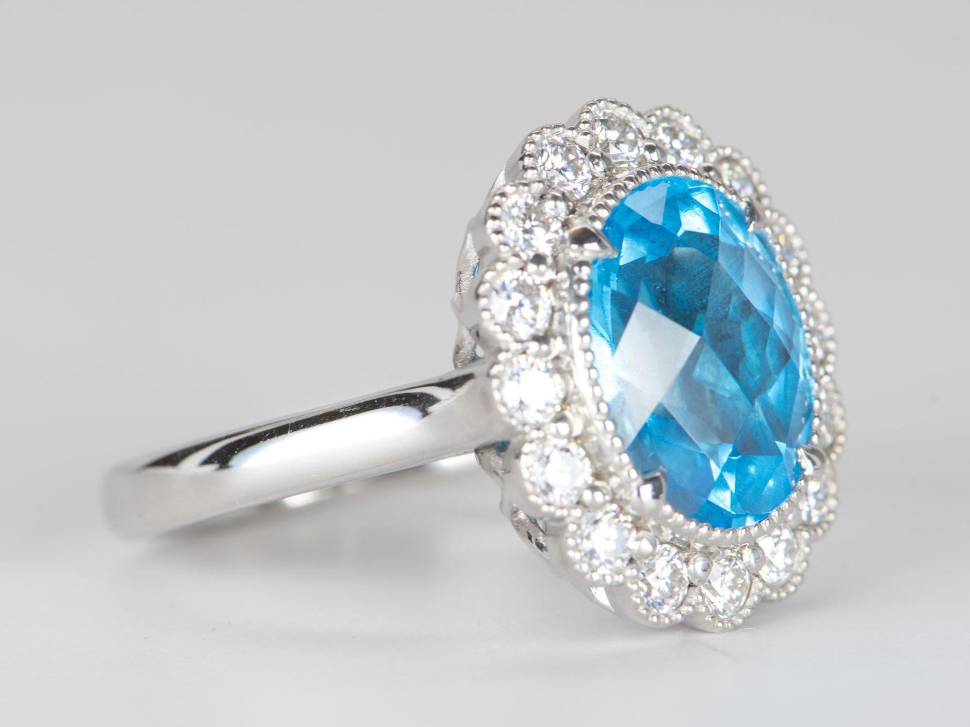 ♥ 5.27ct Swiss Blue Topaz with Moissanite Halo 9K White Gold Statement Ring
♥ Solid 9k white gold ring set with a beautiful oval-shaped topaz
♥ Gorgeous blue color!
♥ The item measures 17.9 mm in length, 15.8 mm in width, and stands 8.2 mm from the