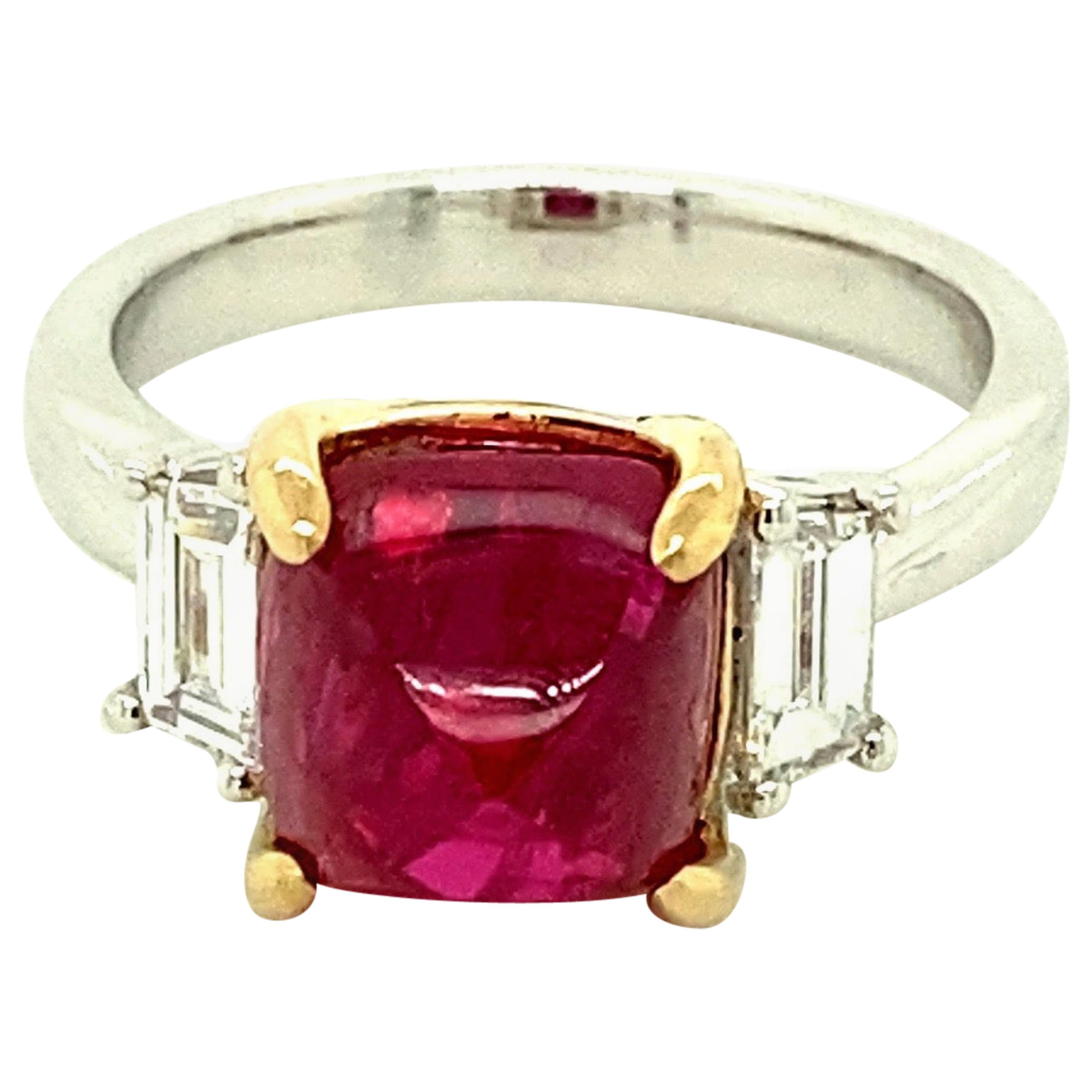 5.28 Carat Burmese Red Spinel Sugarloaf and White Diamond Gold Engagement Ring:

A beautiful ring, it features a stunning 5.28 carat unheated Burmese red spinel sugarloaf with baguette white diamonds on both sides of the spinel weighing 0.49 carat.