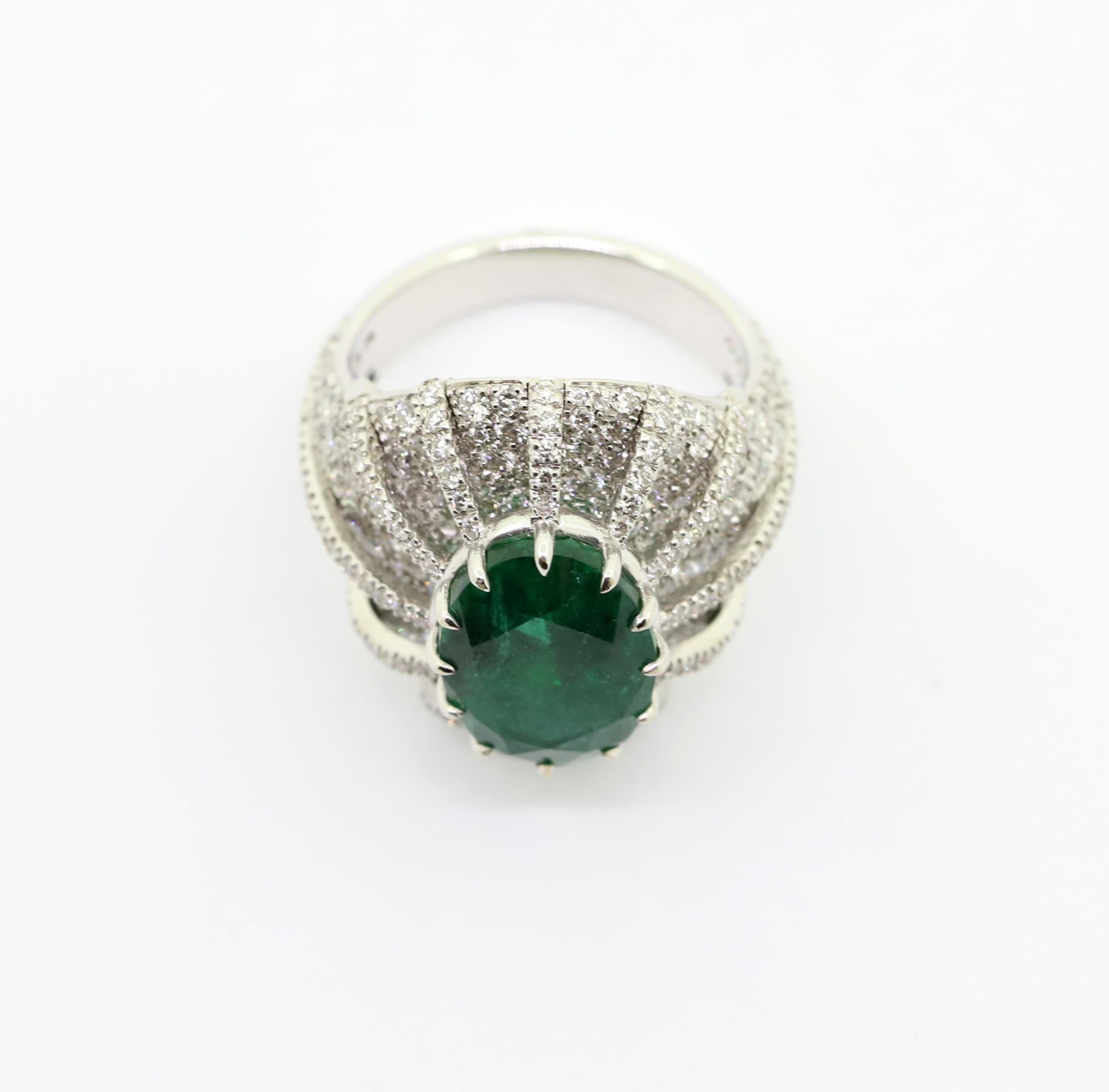 Elegant 18kt White Gold Cocktail  Ring featuring a Vibrant 5,28 Carat Oval Emerald, surrounded by White Diamond pavè of 2.40 Carat total.
This ring is entirely Hand-Made in Italy.

