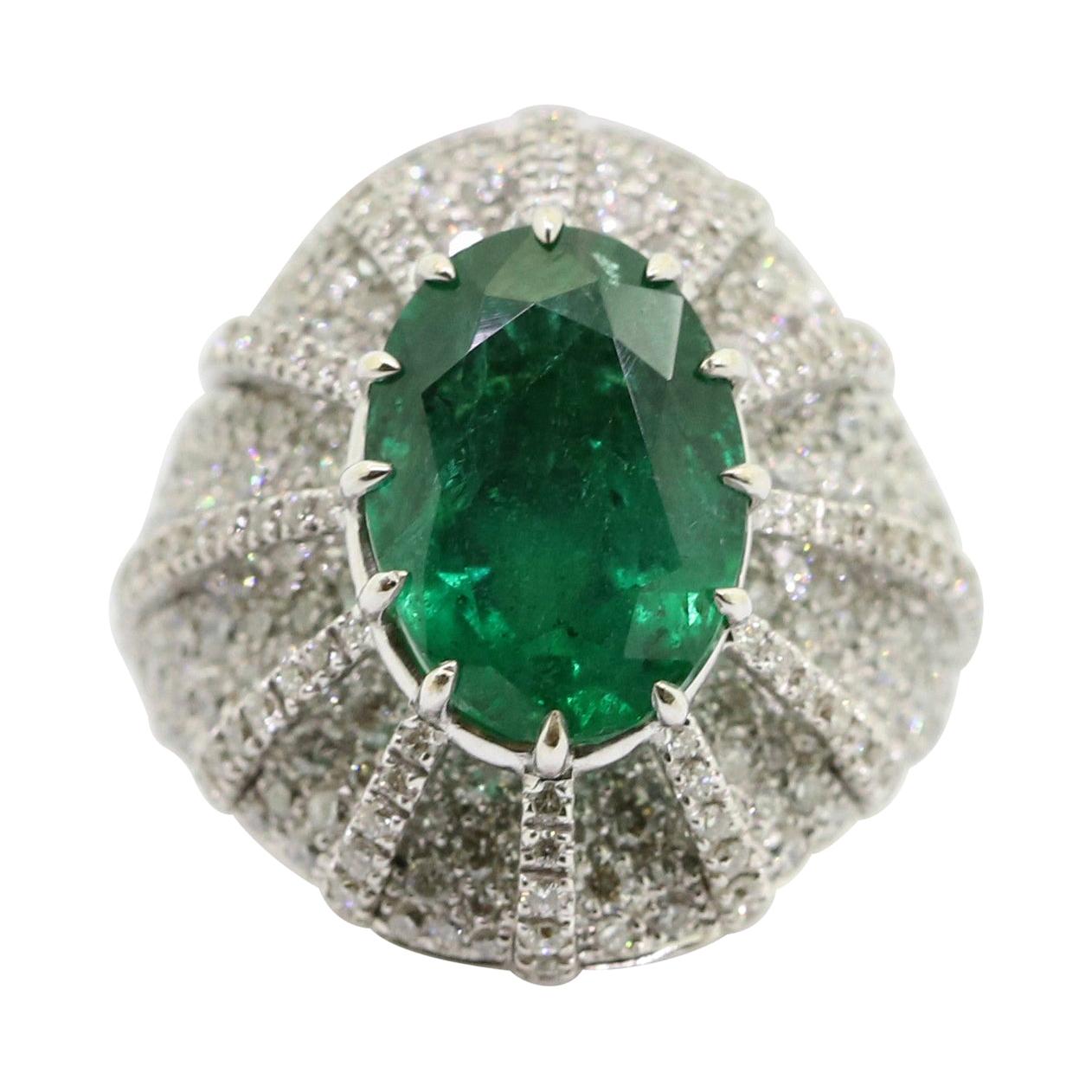 5.28 Carat Oval Emerald and 2.40 Carat White Diamonds Cocktail Ring For Sale
