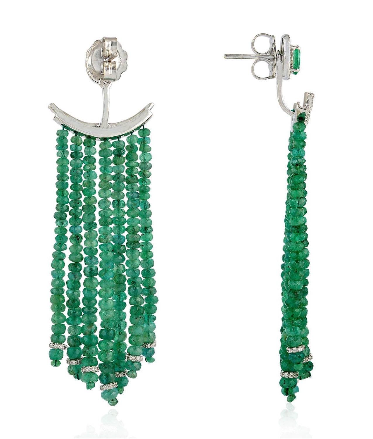 These chandelier earring jackets are rendered in lustrous 18-karat gold and feature a diamond-encrusted emerald stud. The pair is accented with cascading strands of 52.82 carats emeralds and 1.53 carats of diamond. Can be worn alone as studs and