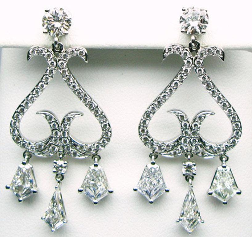 These fashionable handmade platinum earrings are 5.29 carats. They each feature 3 sparkling kite cut diamonds weighing a total of 3.12 carats, 2 round brilliants weighing 1.22 carats, and a pave set of diamonds weighing 0.95 carats. Their stunning