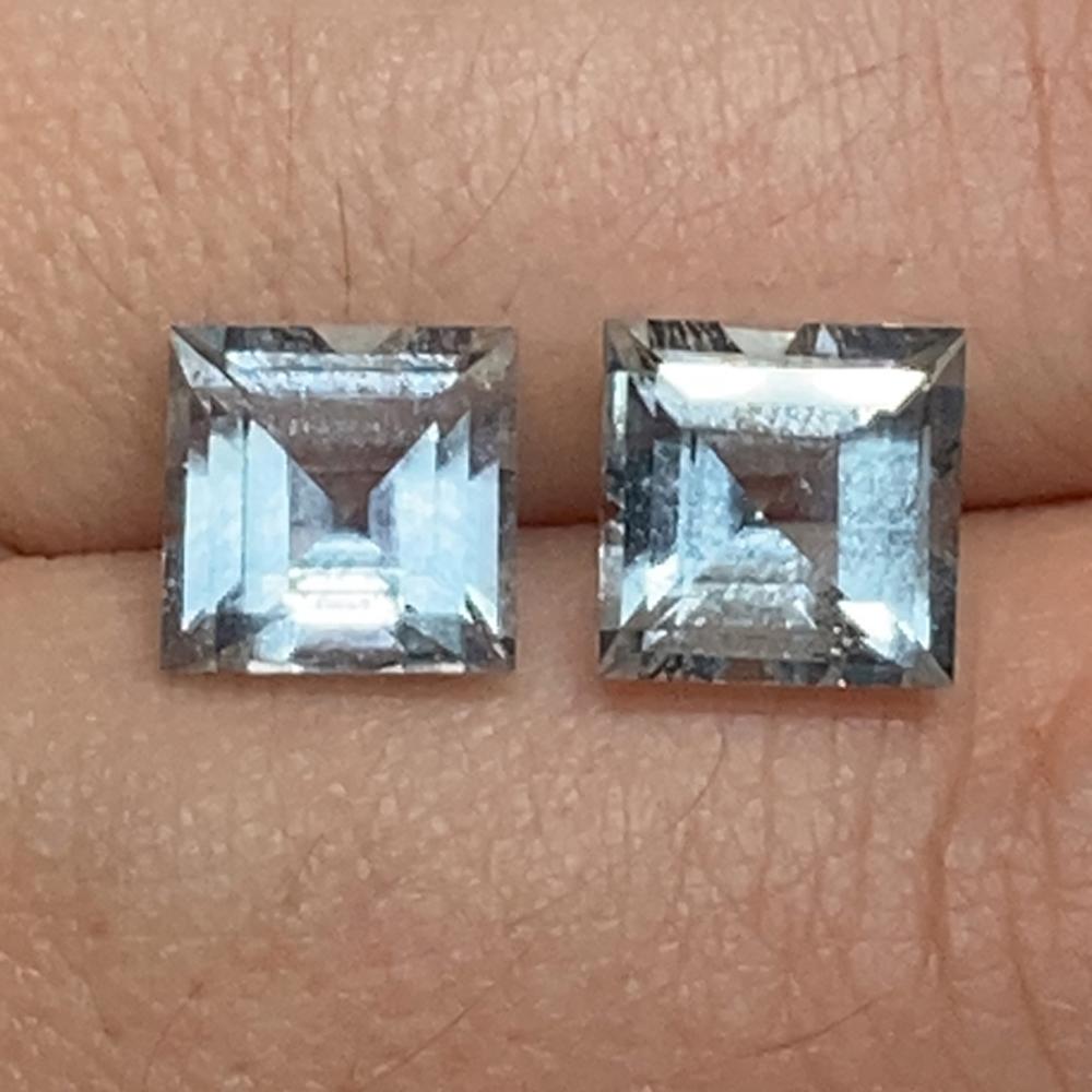 Description:

Gem Type: Aquamarine 
Number of Stones: 2
Weight: 5.2 cts
Measurements: 8.04 x 8.04 x 5.82 mm and 7.83 x 7.84 x 5.68 mm
Shape: Square
Cutting Style Crown: Step Cut
Cutting Style Pavilion: Step Cut 
Transparency: Transparent
Clarity: