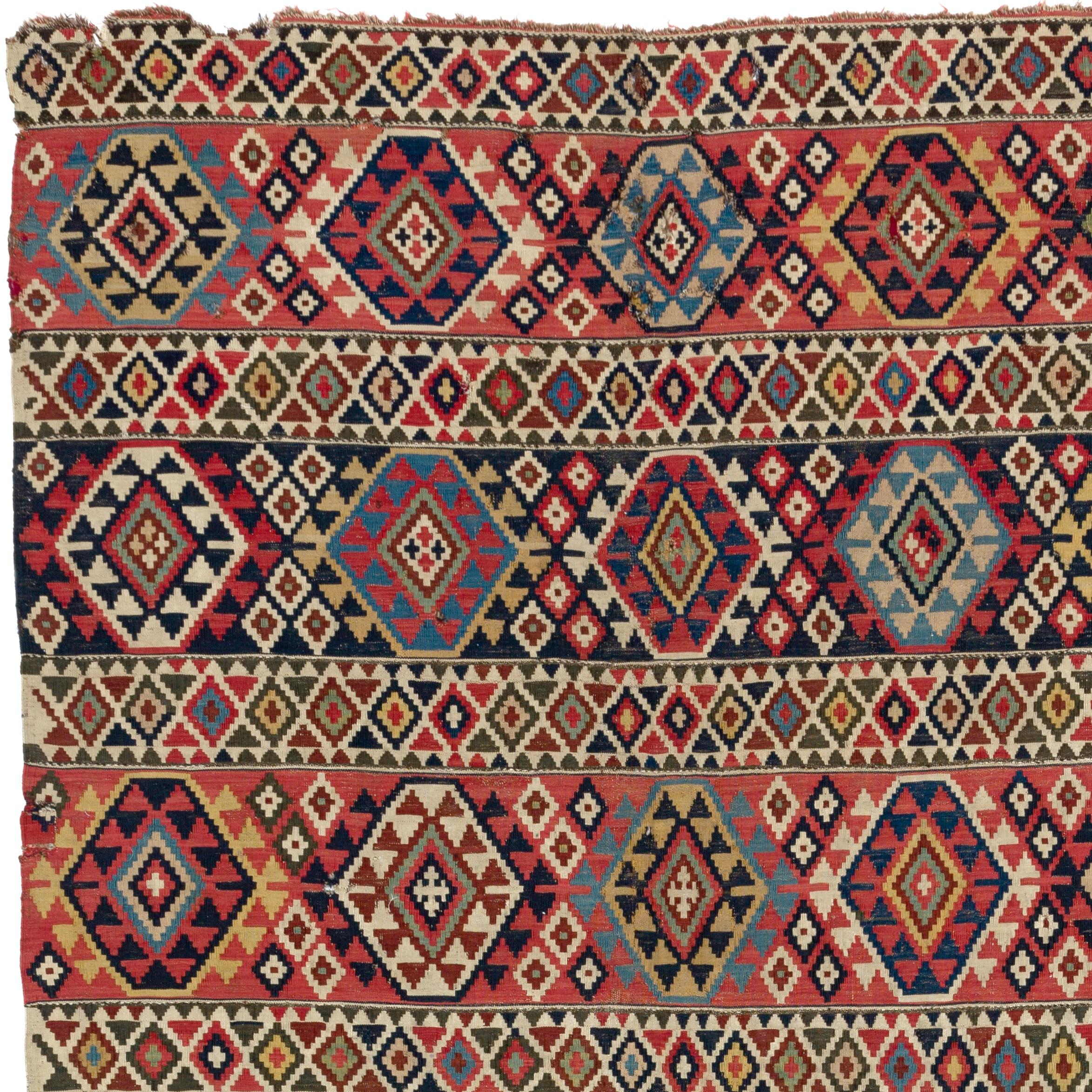 A rare antique Caucasian Shirvan Kilim (flat-woven rug) with wonderfully saturated natural dyes and beautiful geometric design. Very good condition. Sturdy and as clean as a brand new rug (deep washed professionally). Measures: 5.2 x 10 ft.
