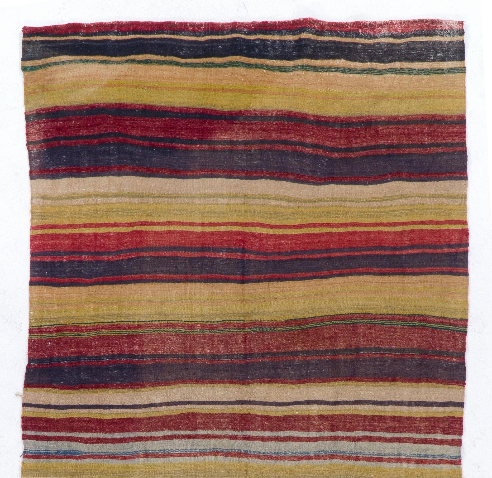 Vintage handwoven flat-weave (kilim) runner with striped design. 100% Wool in yellow, beige, red, black and green colors. 
Ideal for both residential and commercial interiors. 
We can supply a suitable rug-pad if requested for extra cushioning and