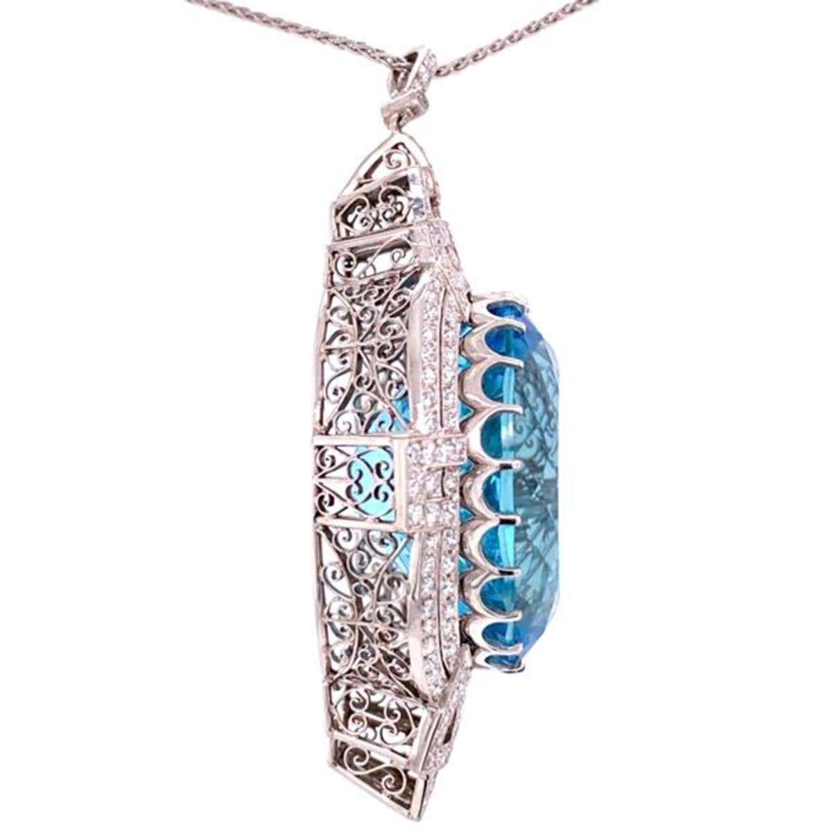 Simply Beautiful! Finely detailed Aquamarine and Diamond Pendant Necklace, center securely set with an Aquamarine, weighing approx. 53.00 Carat total weight surrounded by  Diamonds, weighing approx. 3.50 Carat total weight. Filigree design mounting