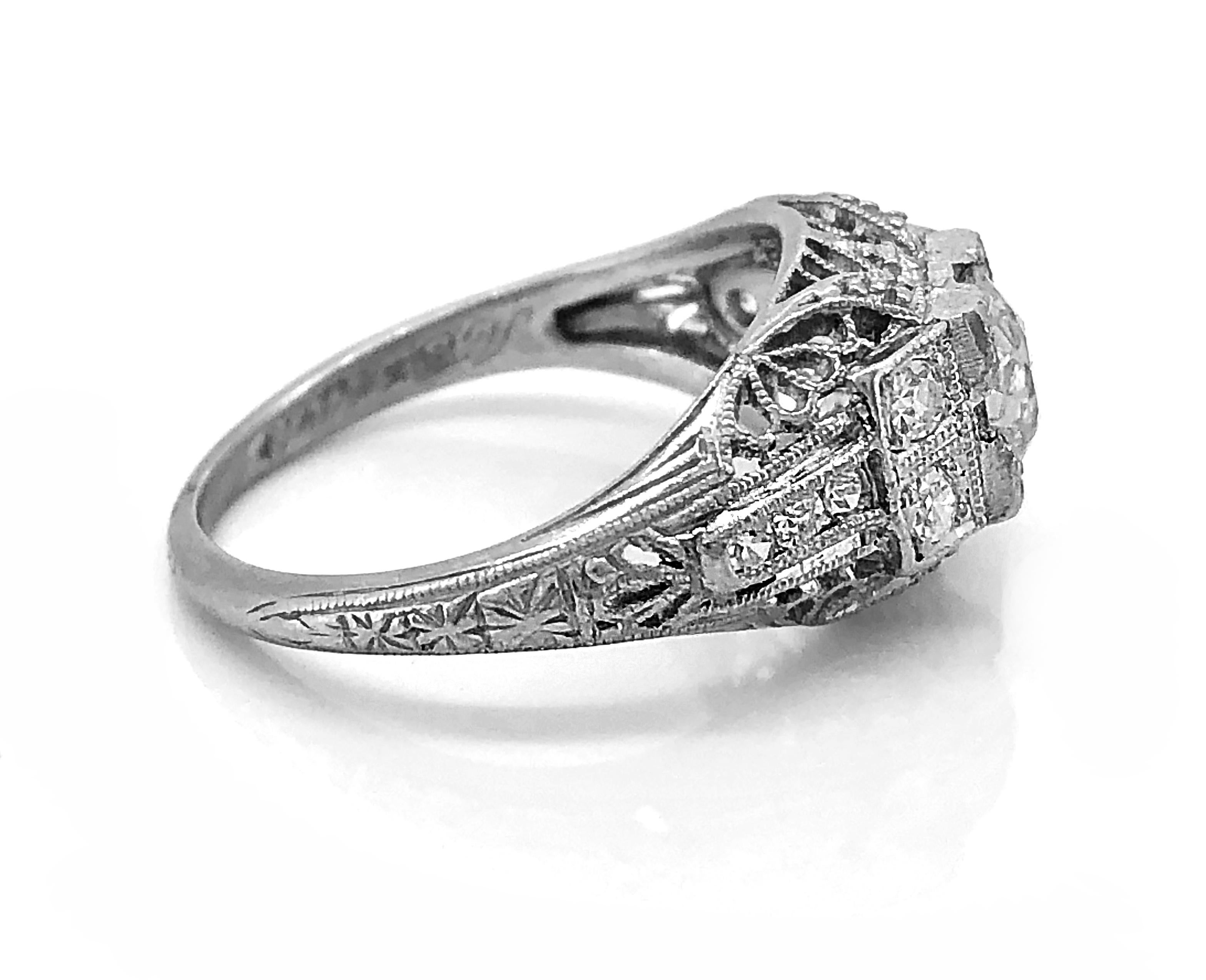 An exceptional Platinum & Diamond Art Deco Antique Engagement Ring by S. Kind & Son. This beautiful ring is highlighted by gorgeous filigree & pierced decoration, supporting a .53ct. apx. European cut diamond that is VS2 in clarity and H in color.