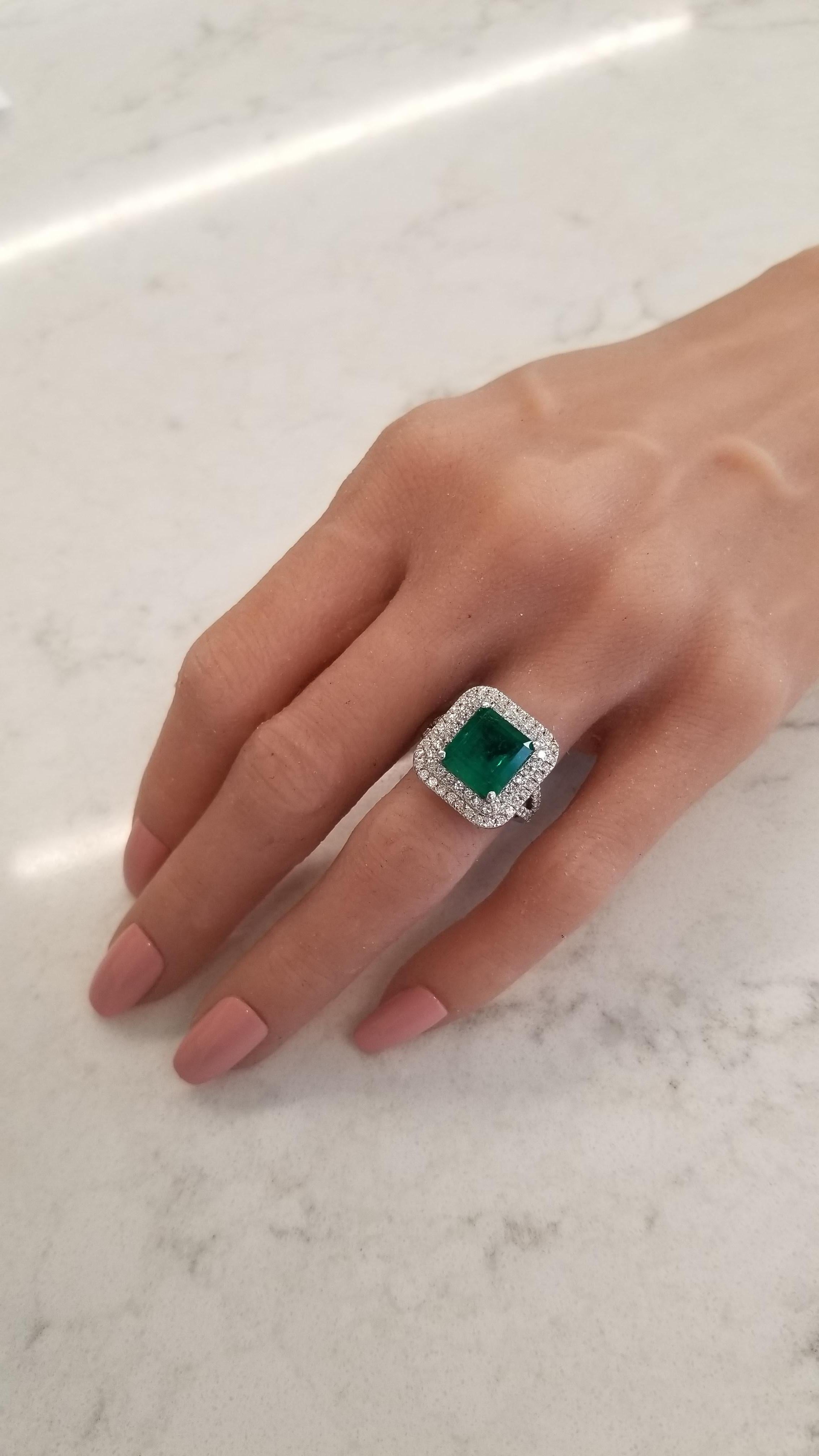 This is a fine green Columbian emerald cut weighing 5.30 carat. It is a square emerald cut that is prong set and measures 10.12x9.58mm. Its color is bright, vibrant green. Its color is evenly distributed throughout the gem. Sparkling round brilliant