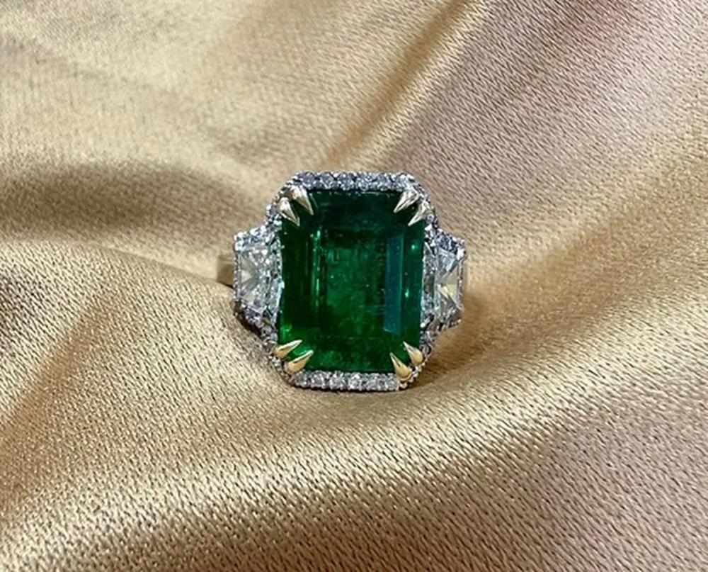 Emerald Cut 5.30 Carat Emerald halo three stone ring For Sale