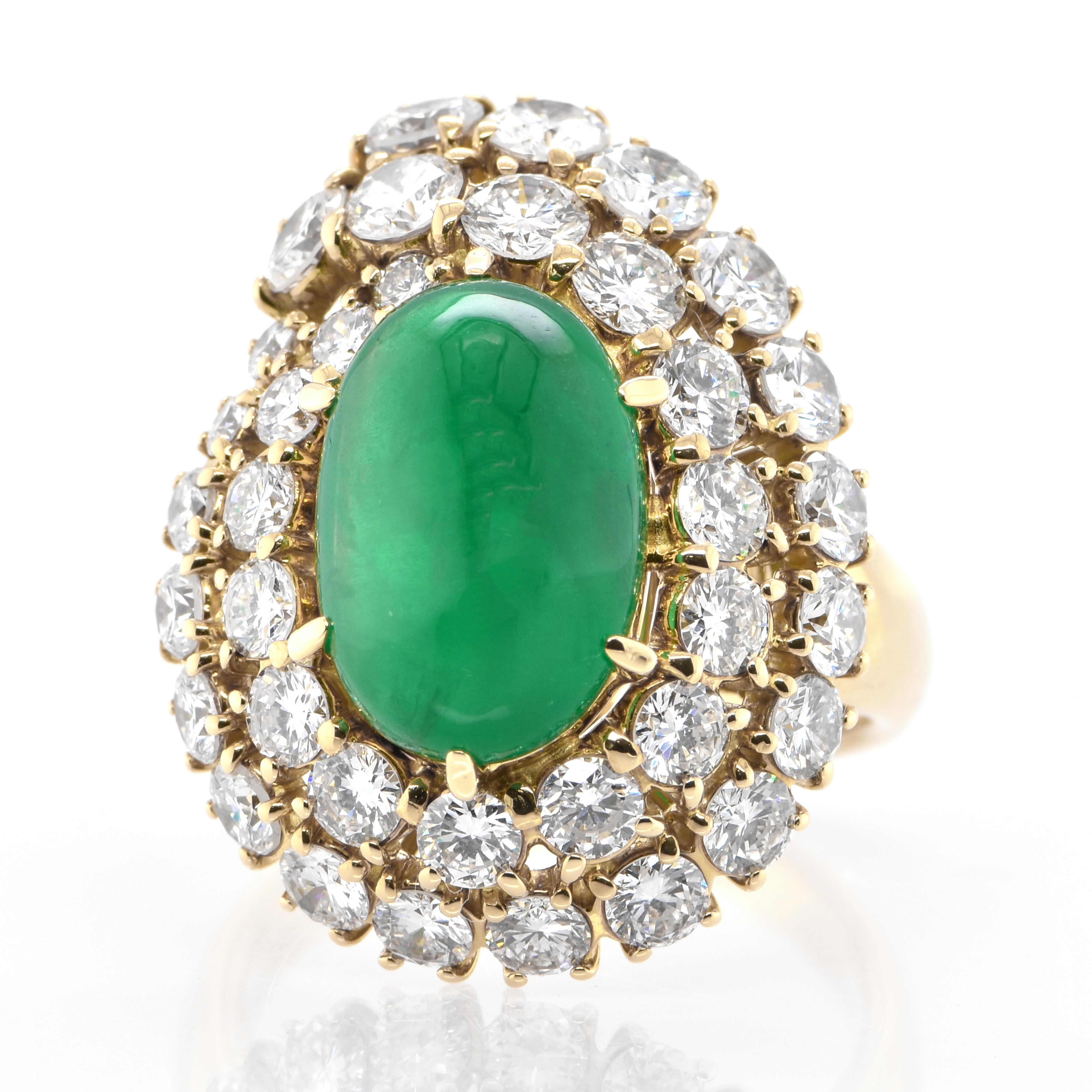 A stunning ring featuring a 5.30 Carat Natural Emerald Cabochon and 3.35 Carats of Diamond Accents set in 18 Karat Yellow Gold. People have admired emerald’s green for thousands of years. Emeralds have always been associated with the lushest
