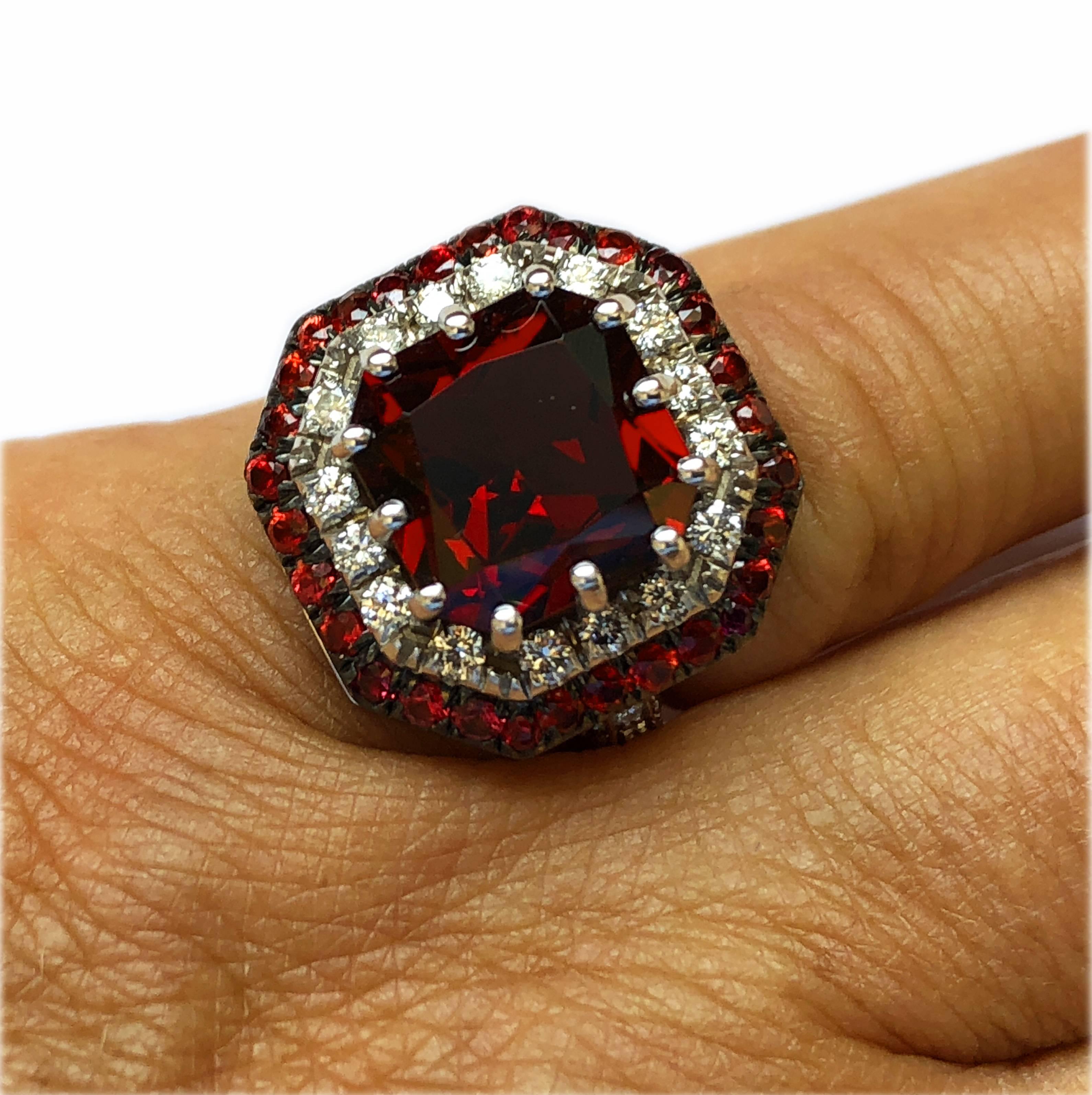 One-of-a-kind, Beautiful 5.30 Carat Natural Octagonal Cut Spessartine in a Sumptuos 0.94 Carat Ruby, 0.73 Carat White Diamond, 18 Kt White and Black Gold Setting

This one-of-a-kind stone shows an uncommon brilliant, vivid red color, the pictures