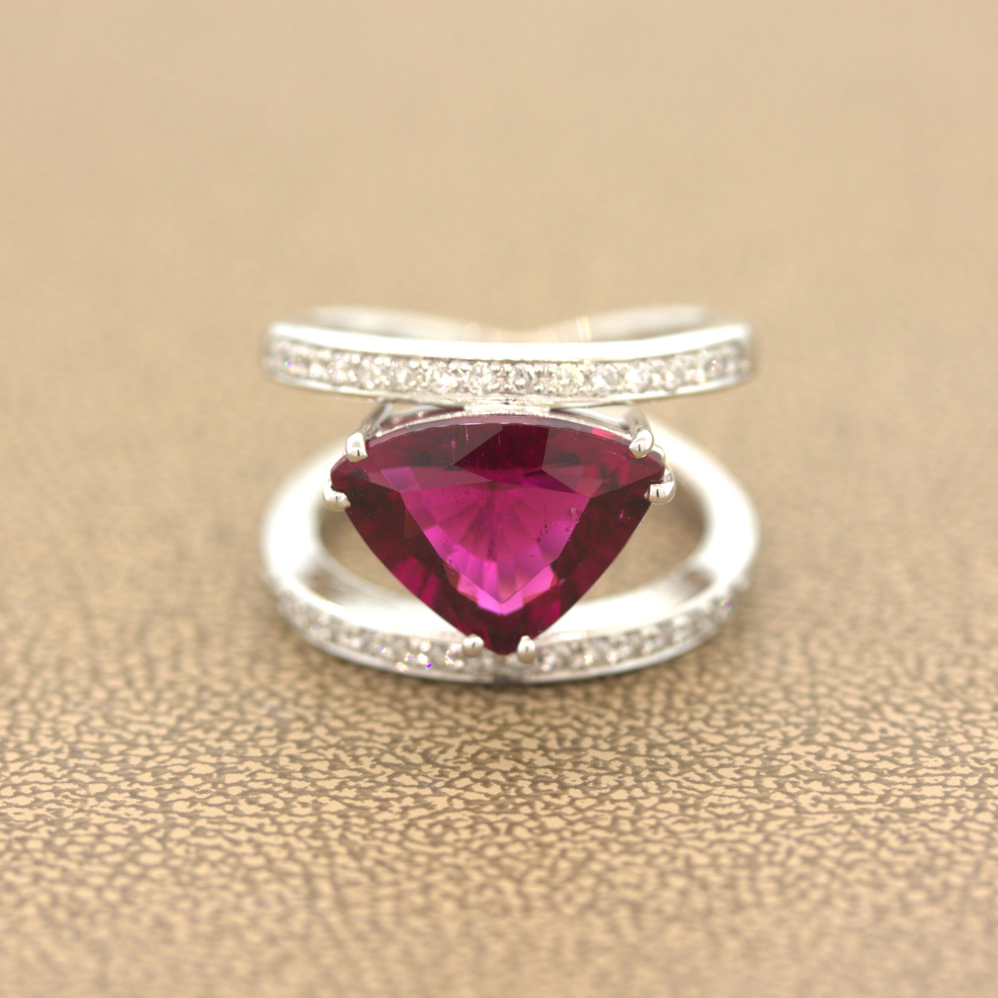 A rich beautiful gem takes center stage! It is a 5.30 carat rubellite tourmaline with a deep and brilliant red color that rivals the best rubies on the market. Complementing the fine tourmaline are 0.38 carats of round brilliant-cut diamonds adding