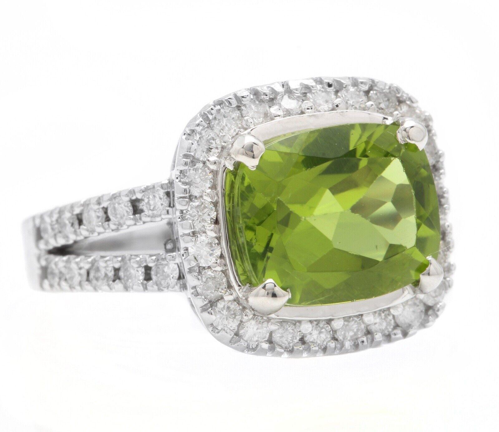 5.30 Carats Natural Very Nice Looking Peridot and Diamond 14K Solid White Gold Ring

Suggested Replacement Value:  $5,500.00

Total Natural Cushion Peridot Weight is: Approx. 4.50 Carats 

Peridot Measures: Approx. 11 x 9mm

Natural Round Diamonds