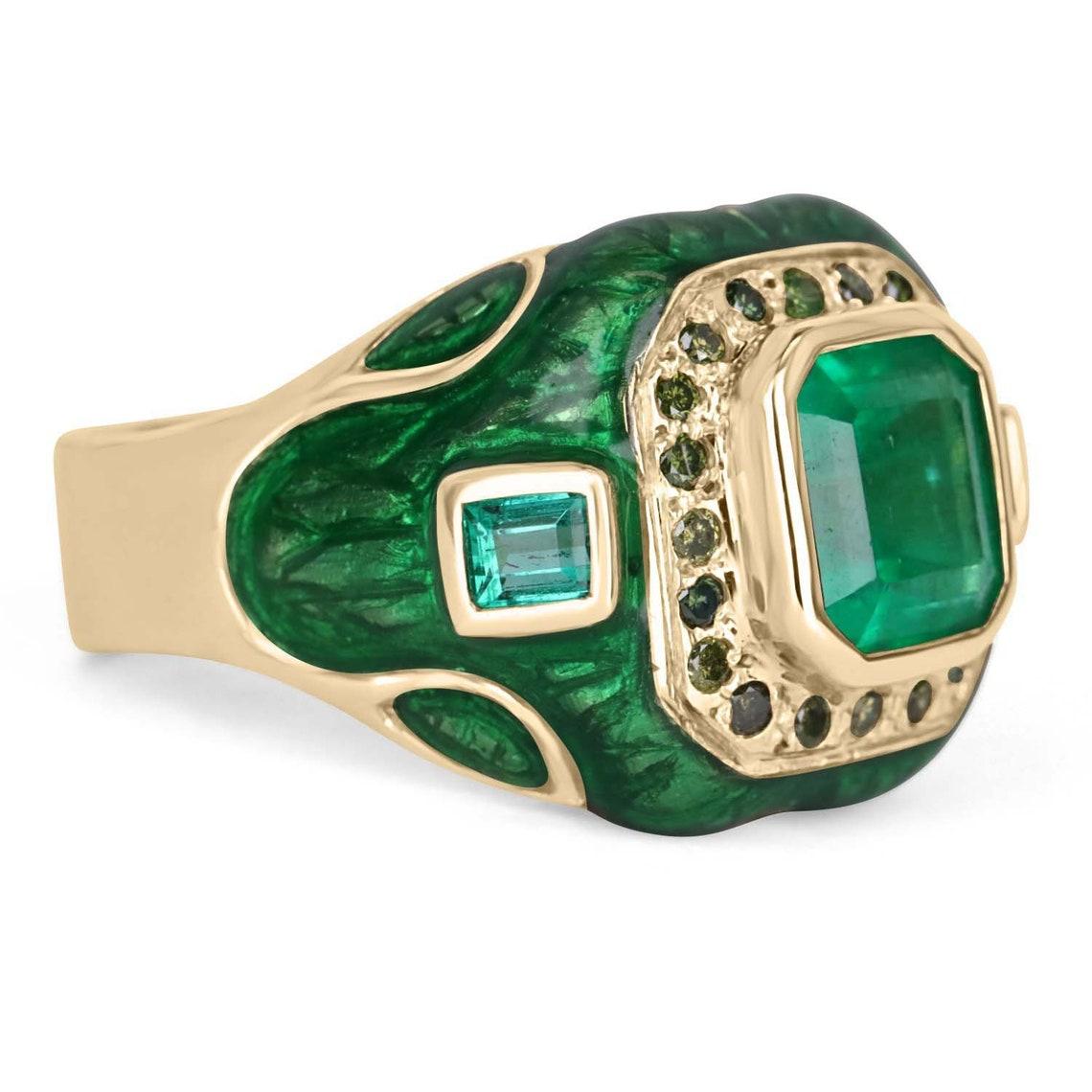 A men's Colombian emerald & green diamond statement ring in 14K gold. This ring features a 4.45-carat Asscher cut emerald in its center. The rare gemstone has a desirable color and transparent eye clarity. The Colombian emerald is bezel set and is